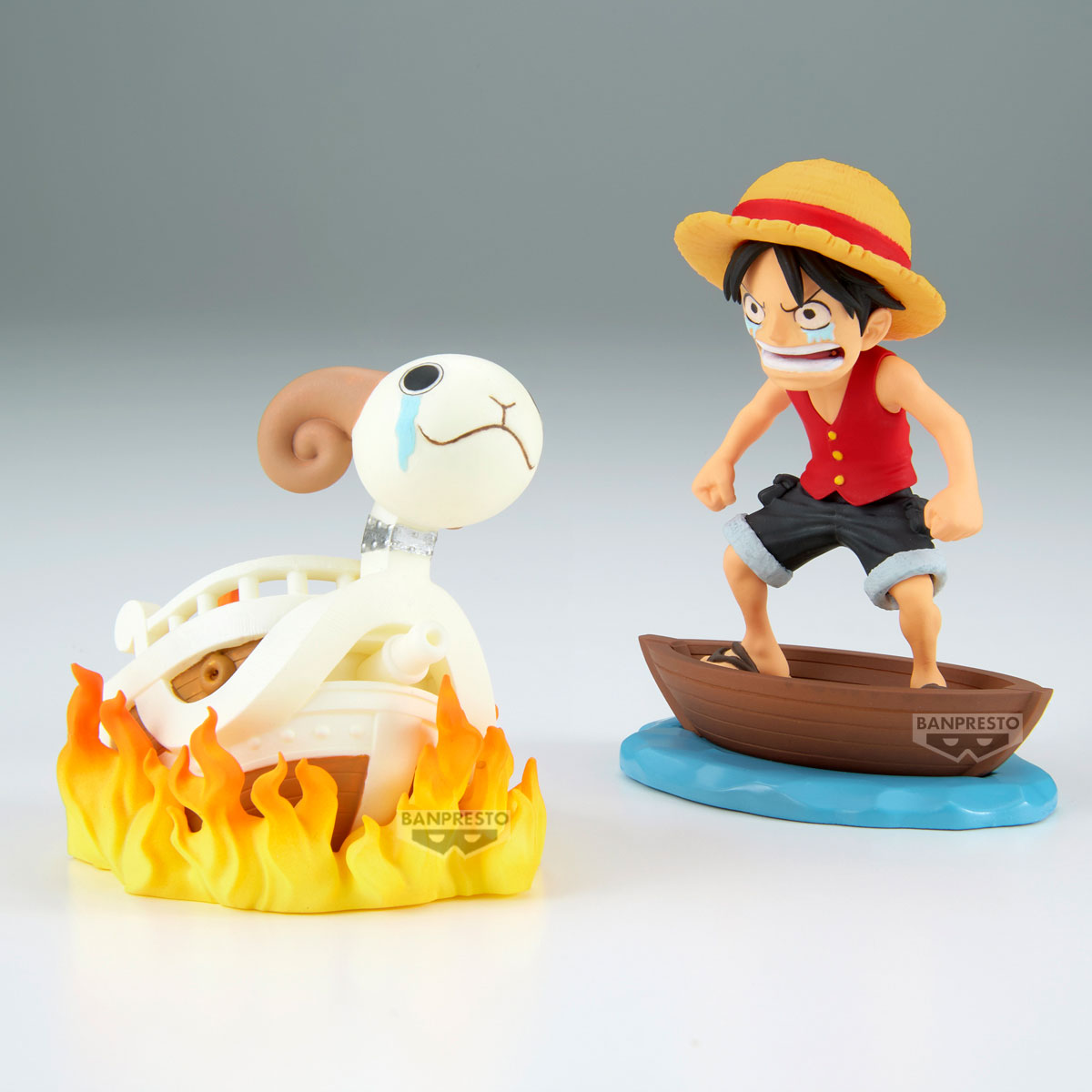 Due figure anime: Luffy in barca e una nave in fiamme. Luffy indossa un cappello di paglia e un gilet rosso. La nave è in fiamme.