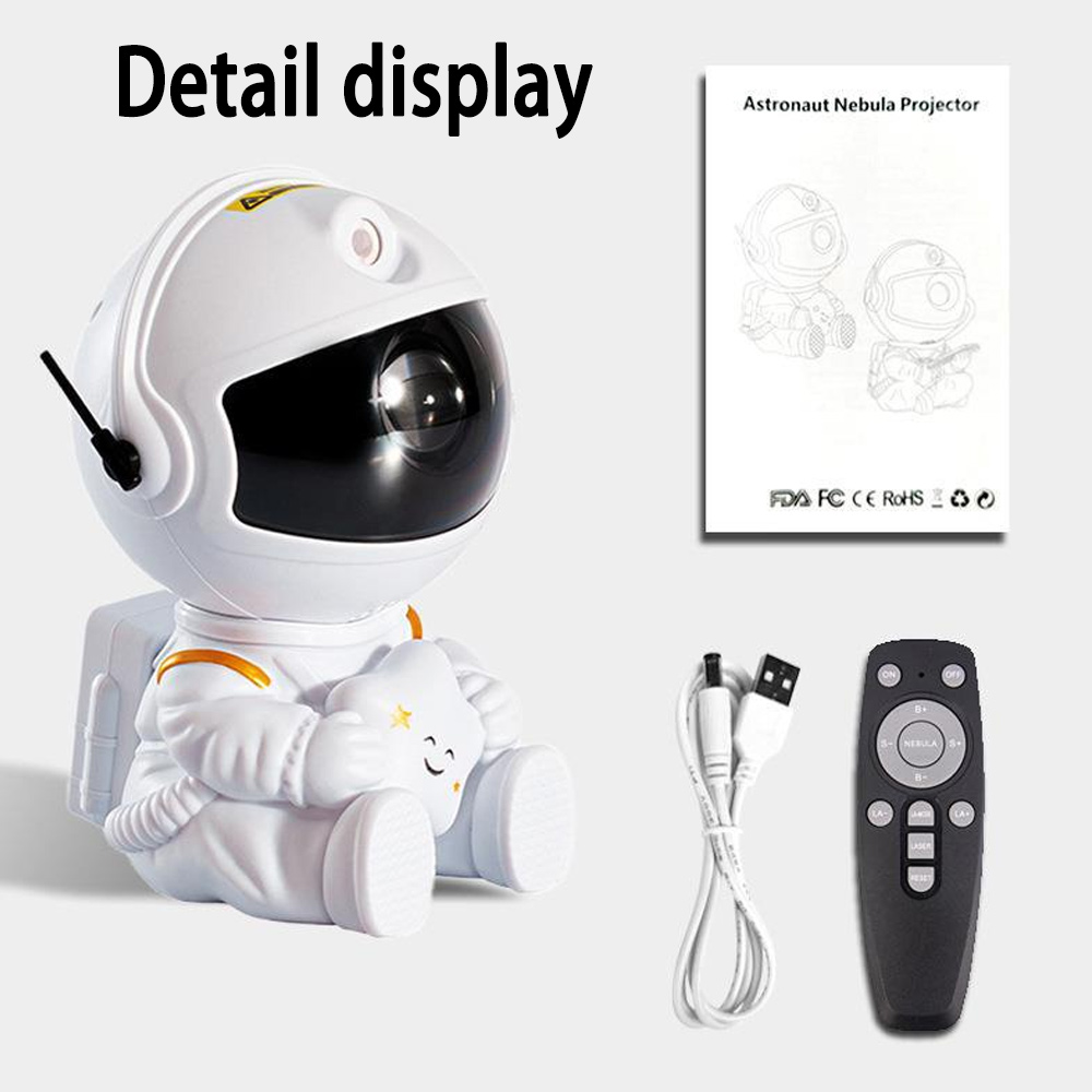 Ein weißer, astronautenförmiger Nebelprojektor steht mit einer Fernbedienung, einem Kabel und einer Anleitung. Der Astronaut hält einen Stern.