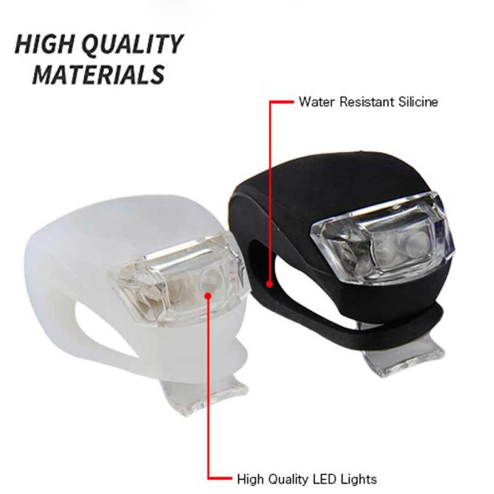 Zwei Fahrradlichter, weiß und schwarz, beschriftet mit 'High Quality LED Lights' und 'Water Resistant Silicone'. Weißer Text 'High Quality Materials'.