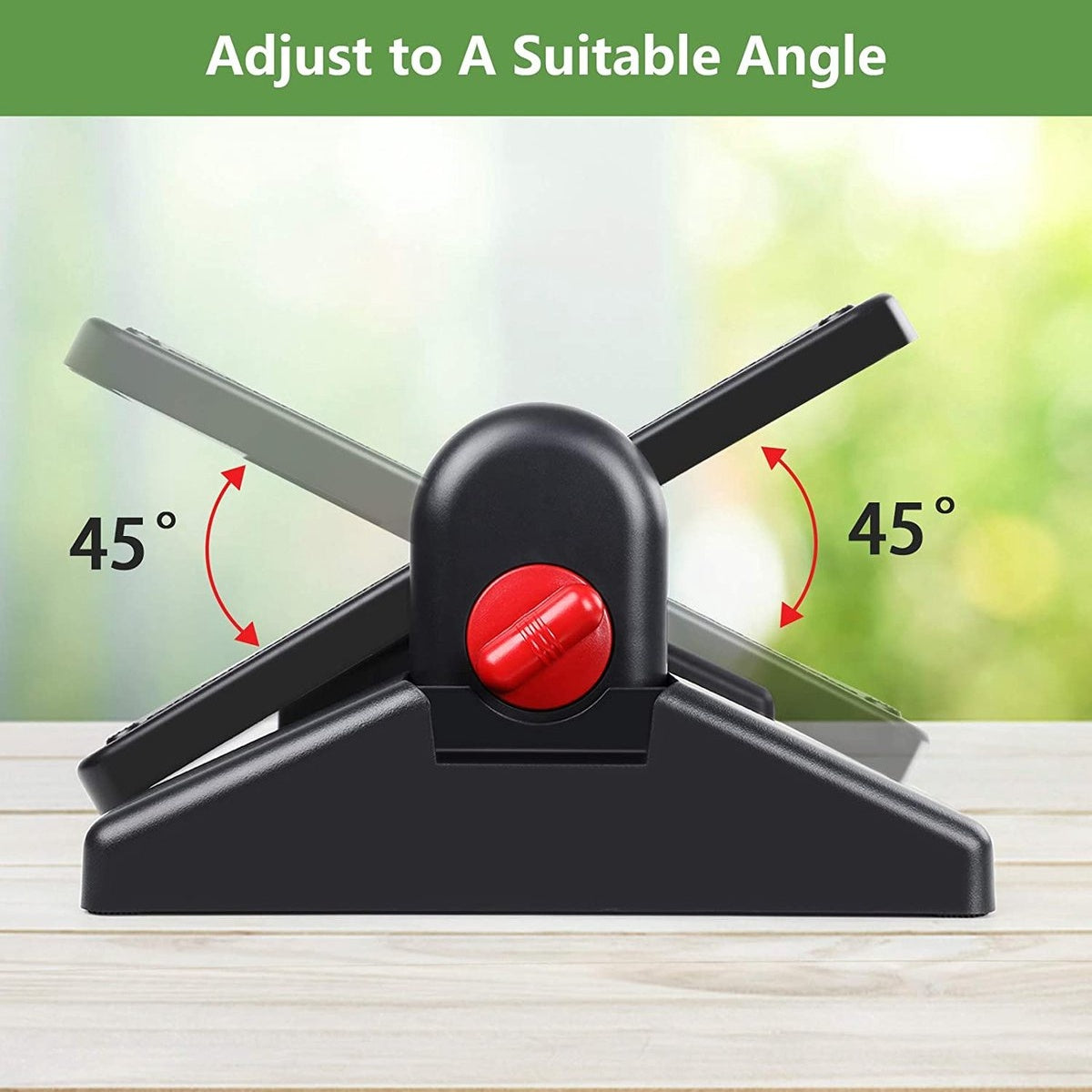 Black adjustable stand with red knob, angled at 45 degrees, on a wooden table. Background blurred green foliage.