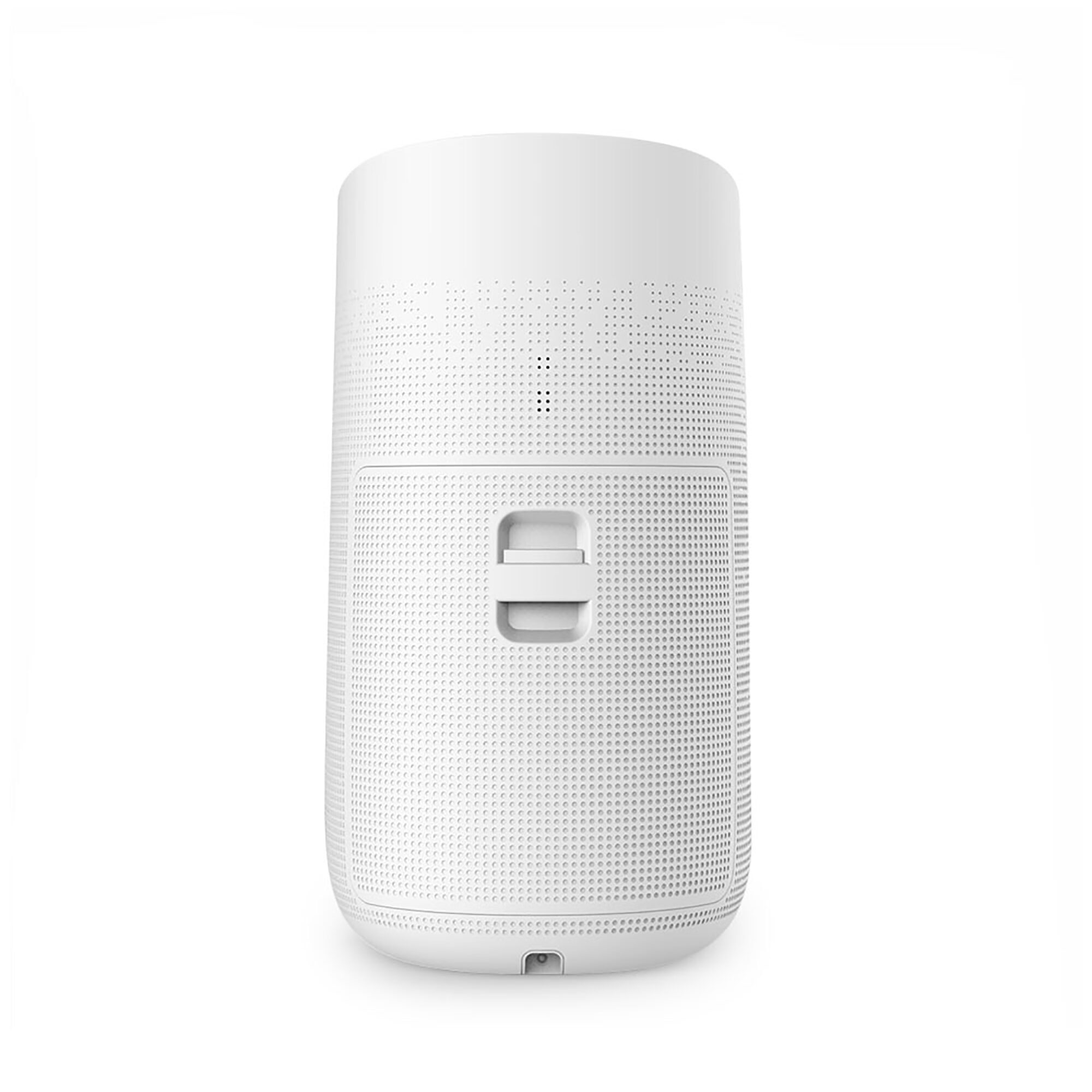 Un altavoz cilíndrico blanco con pequeñas perforaciones y un asa. Está sobre un fondo blanco.
