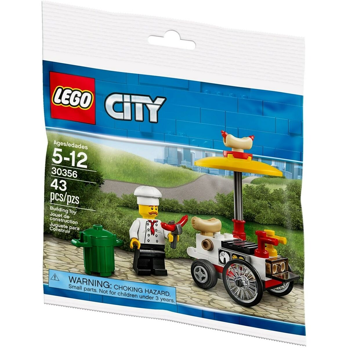 Zestaw LEGO City. Zawiera minifigurkę szefa kuchni z hot dogiem i wózkiem. Wózek ma koła, żółty parasol i hot doga na górze.
