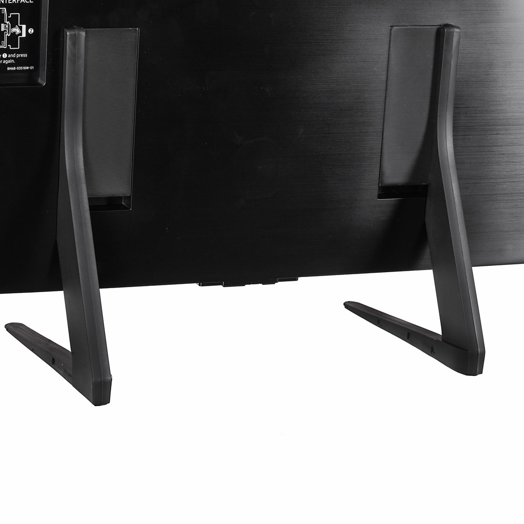 Support de moniteur noir avec deux pieds, un dos rectangulaire et une surface blanche.