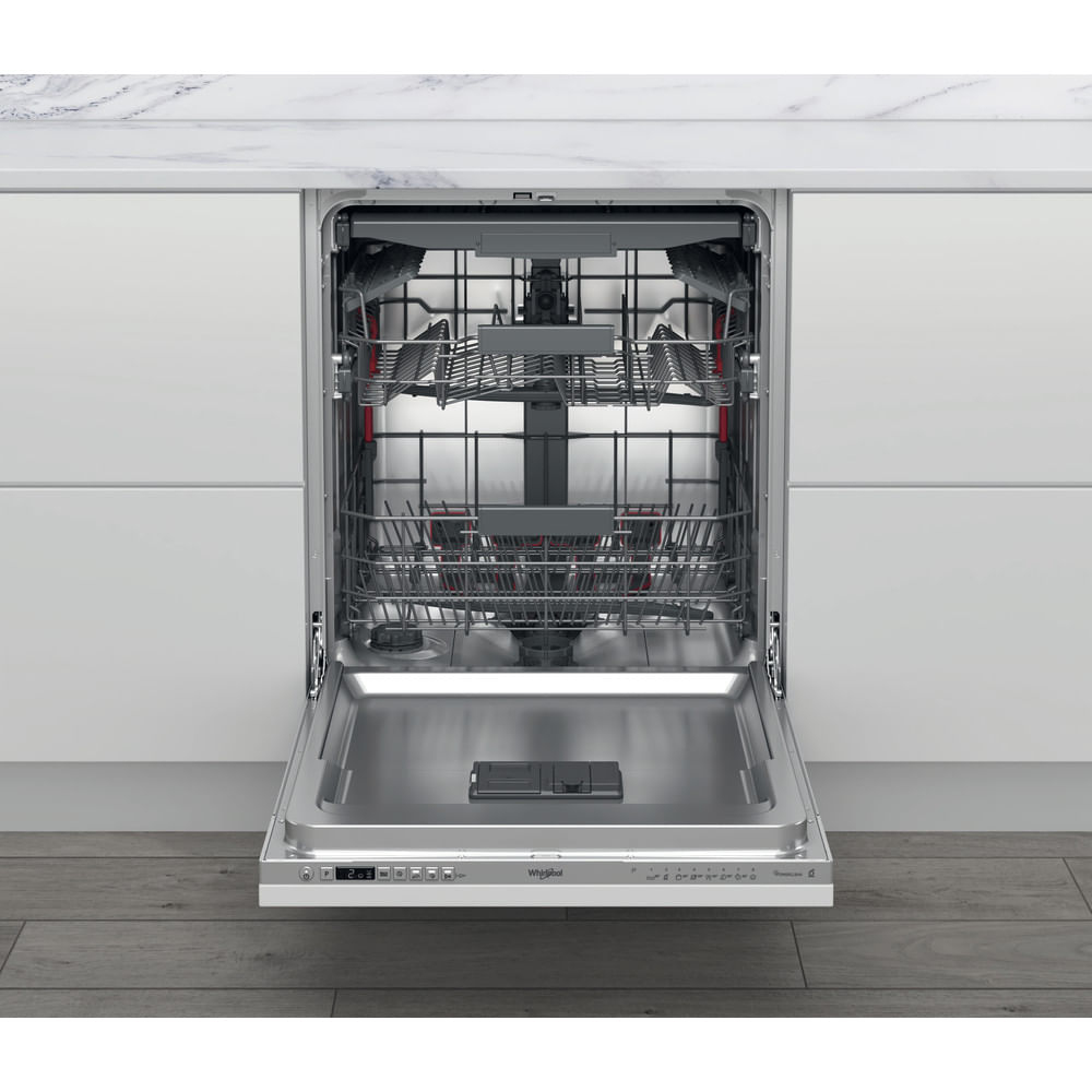 Un lavavajillas Whirlpool abierto. La puerta está abajo, revelando las rejillas. Está instalado en una cocina con encimera de mármol.