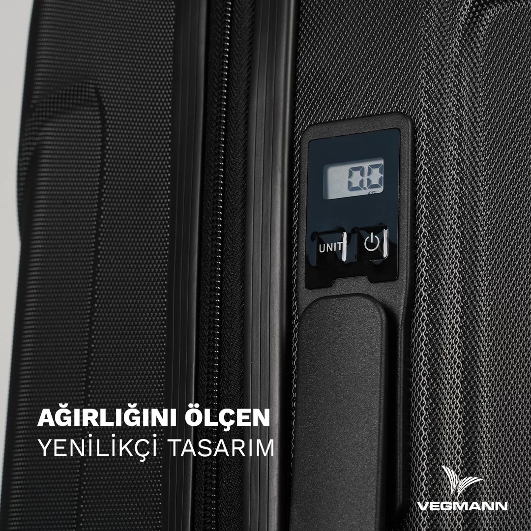 Dijital tartı göstergeli siyah bavul detayının yakın çekimi. Altta Türkçe metin. Sağ altta Vegmann logosu.