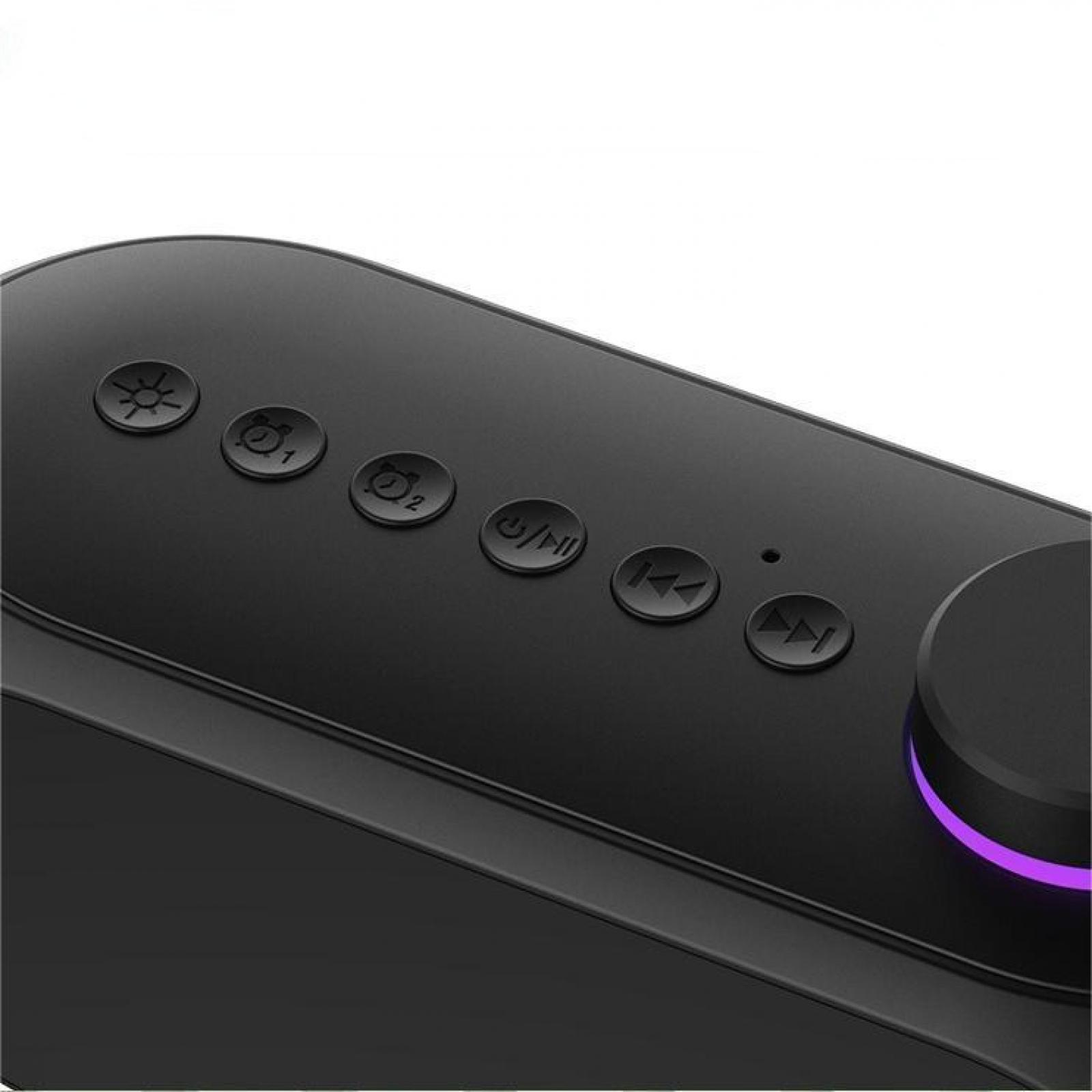 Schwarzes elektronisches Gerät. Tasten für Funktionen wie Strom, Alarme und Wiedergabesteuerung. Ein Drehregler mit violettem Licht.