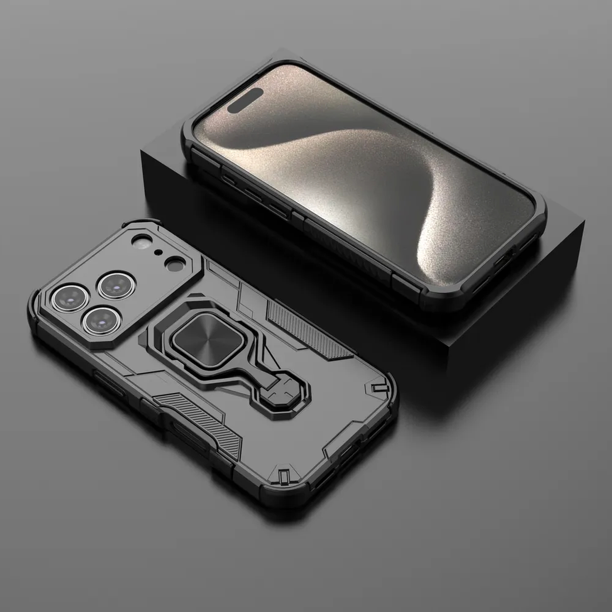 Twee zwarte telefoonhoesjes. Eén staat op een zwart blok. De andere hoes zit eronder, met een ringhouder en camera-uitsparingen.