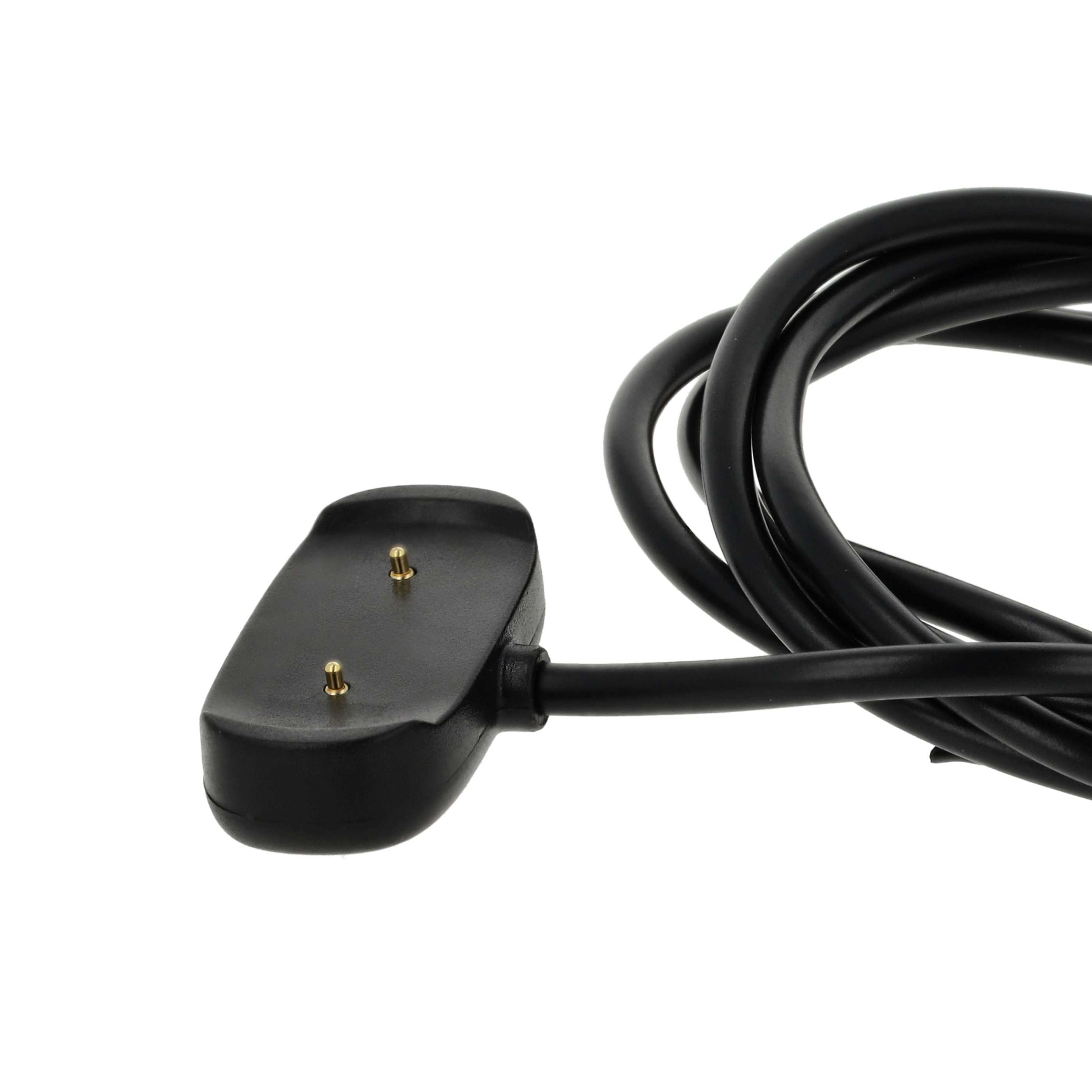 Ein schwarzes Uhrenladegerät mit runder Ladebasis, zwei goldenen Stiften und einem schwarzen Kabel vor weißem Hintergrund.