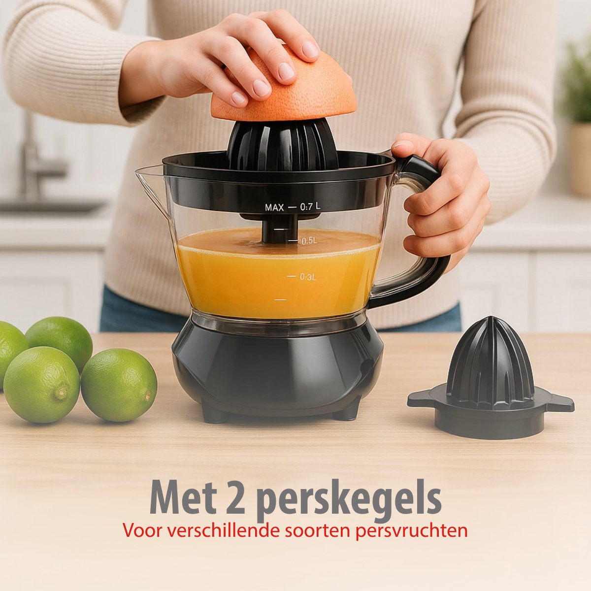 A person juicing a grapefruit with a black juicer. Limes are on the left. The juicer has a clear container with juice.