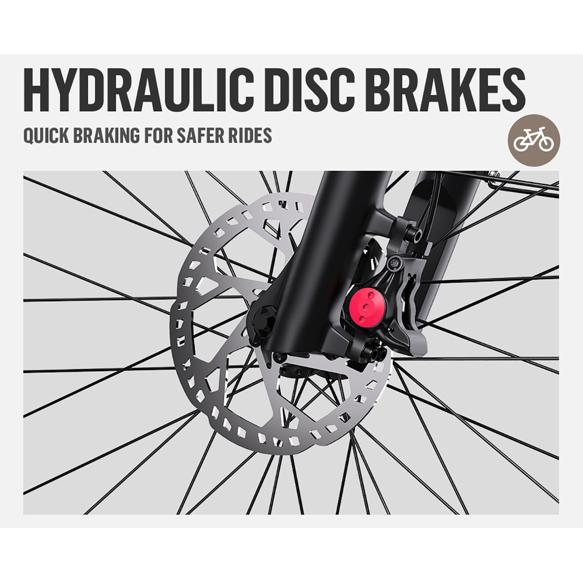 Zbliżenie hydraulicznego hamulca tarczowego roweru. Widoczny srebrny dysk hamulcowy i czerwony zacisk. Czarne szprychy w tle.