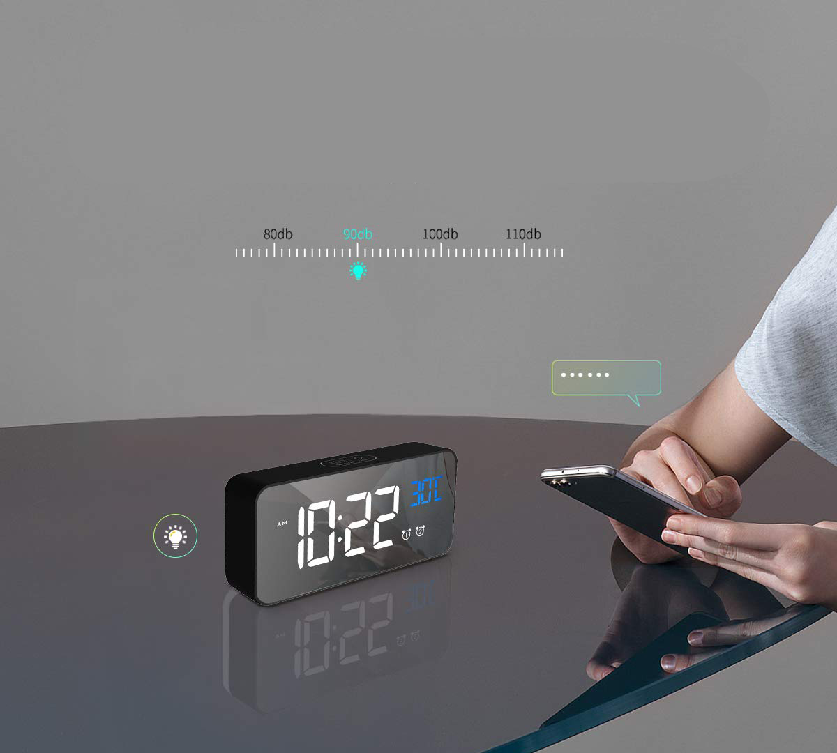 Eine Digitaluhr zeigt 10:22. Eine Person hält ein Telefon. Indikatoren zeigen Helligkeit und Schallpegel. Der Hintergrund ist unscharf.