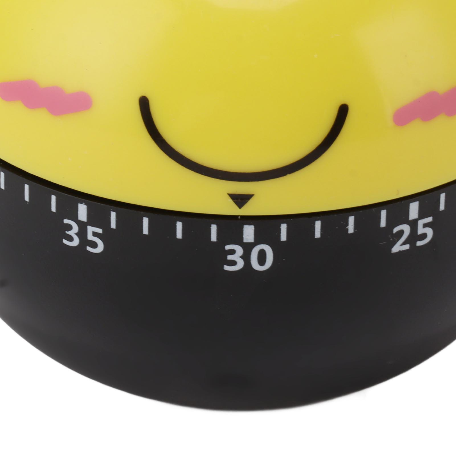 Nahaufnahme eines gelben Küchentimers mit einem Smiley-Gesicht. Schwarzes Zifferblatt zeigt die Zahlen 25, 30, 35. Rosa Rouge-Markierungen.