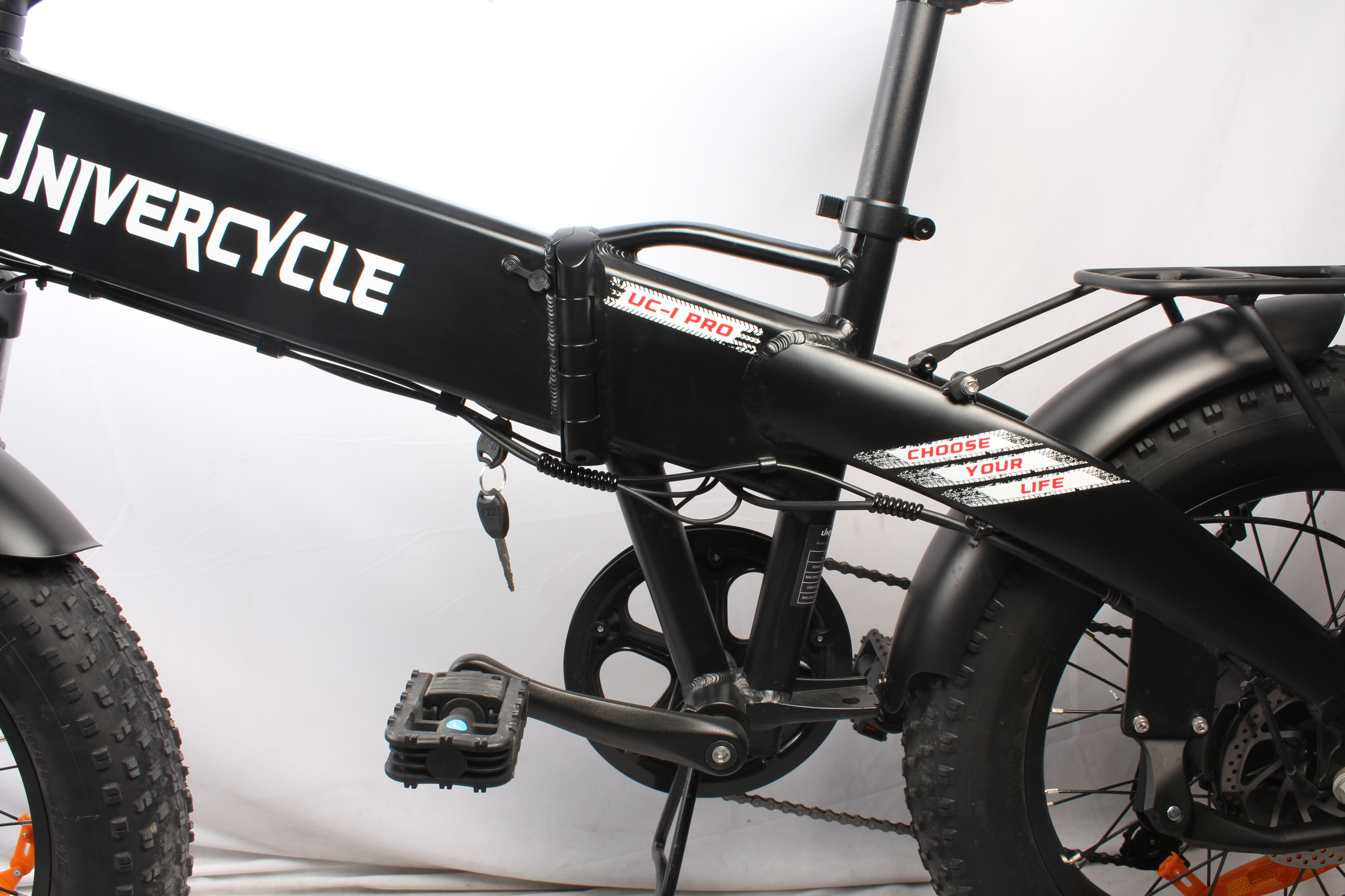 Bicicletta Unicycle nera con scritte bianche. Chiave appesa. Scegli la tua vita scritta sopra. Pneumatici e sella neri.