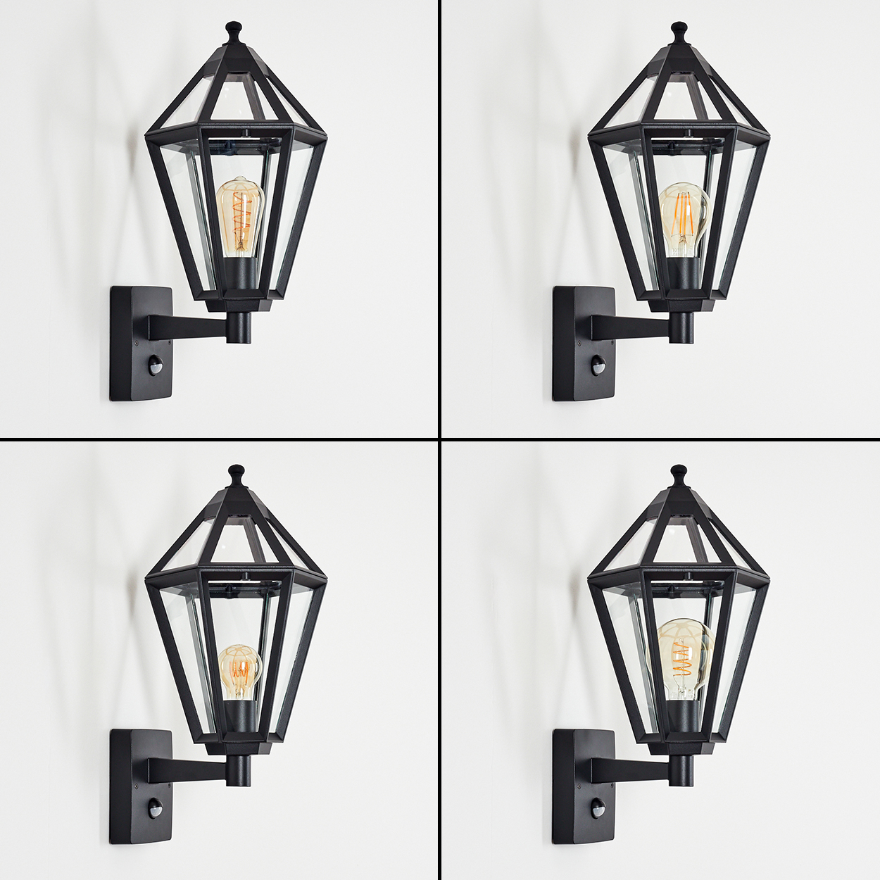 Vier schwarze Au ßenwandlaternen mit Glaspaneelen und Edison-Glühbirnen, montiert an einer weißen Wand.