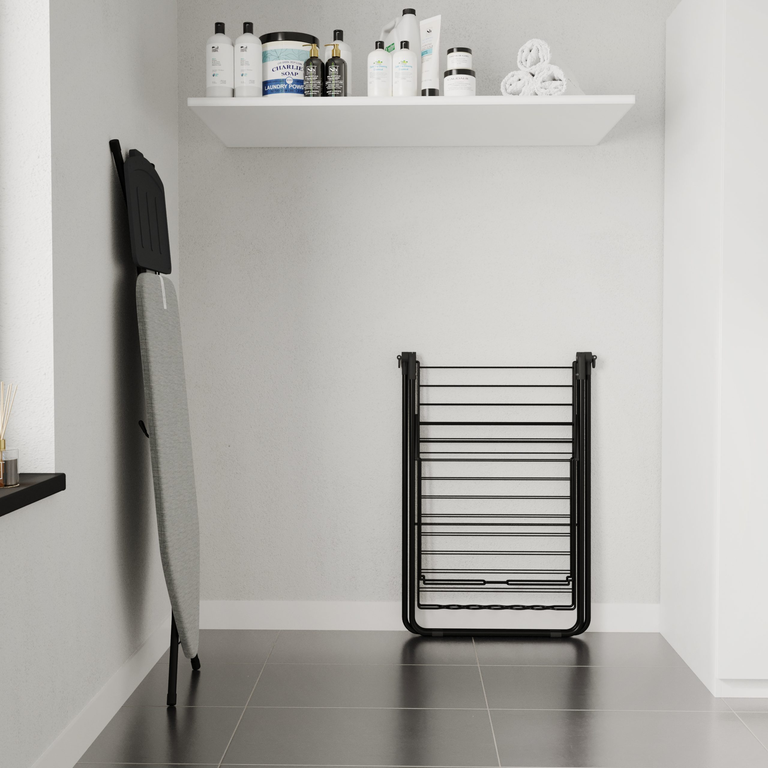 A laundry room with an ironing board, drying rack, and shelf holding products. The floor is tiled.