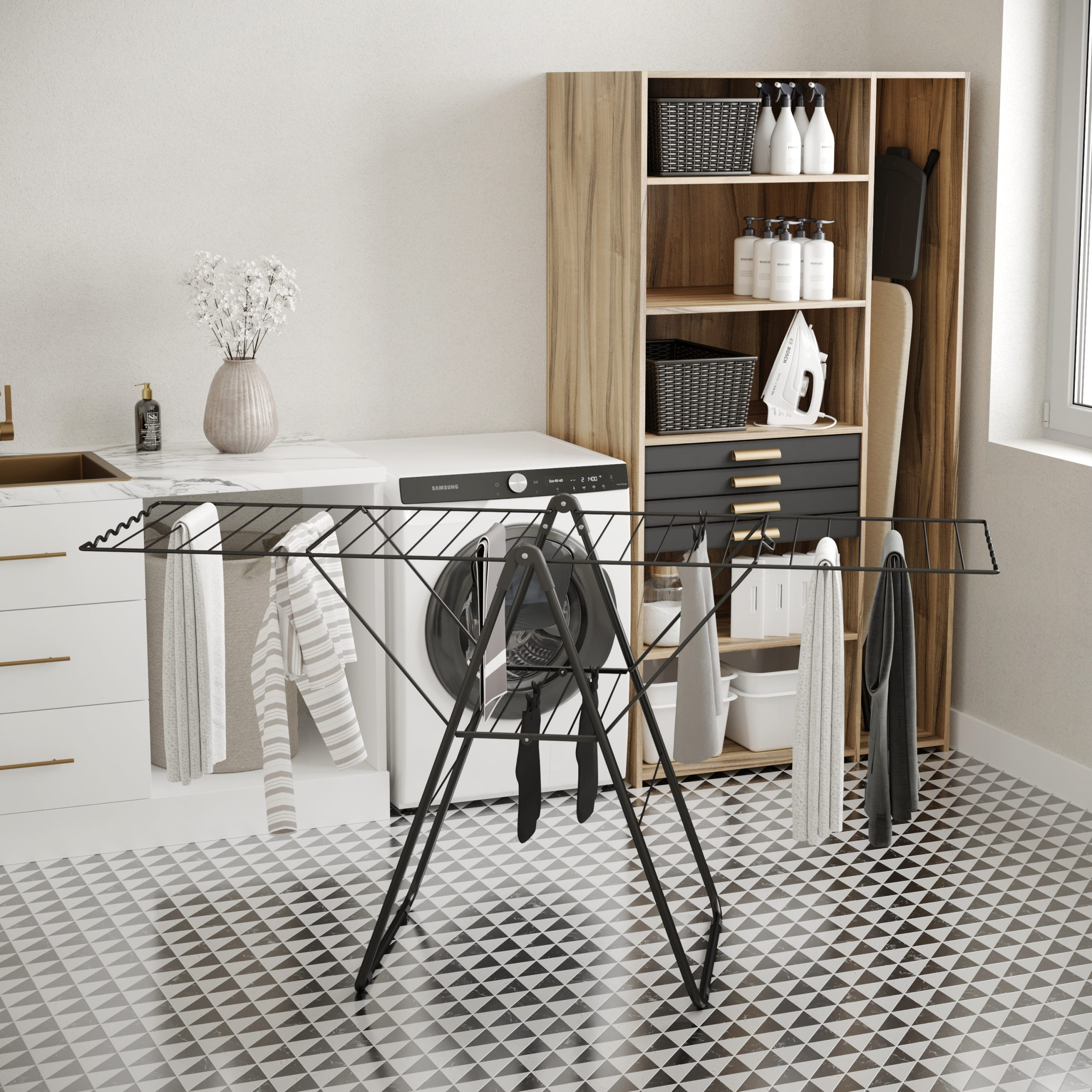 Laundry room with a black drying rack, washing machine, and wooden cabinet. Clothes are hanging.