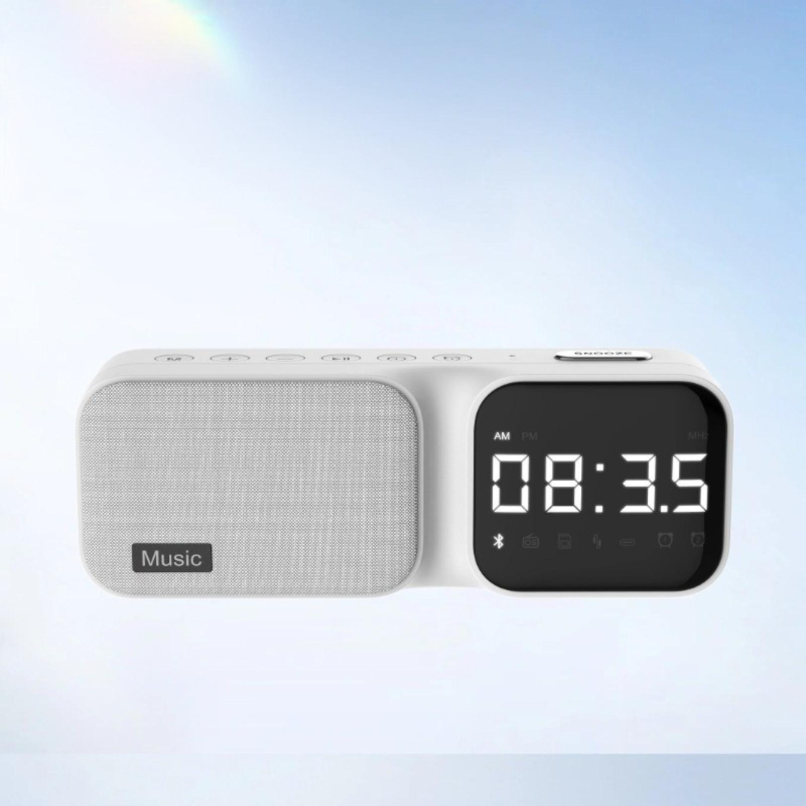 Ein weißer digitaler Wecker mit Lautsprecher. Anzeige zeigt 08:35. Enthält Knöpfe und das Wort "Musik".