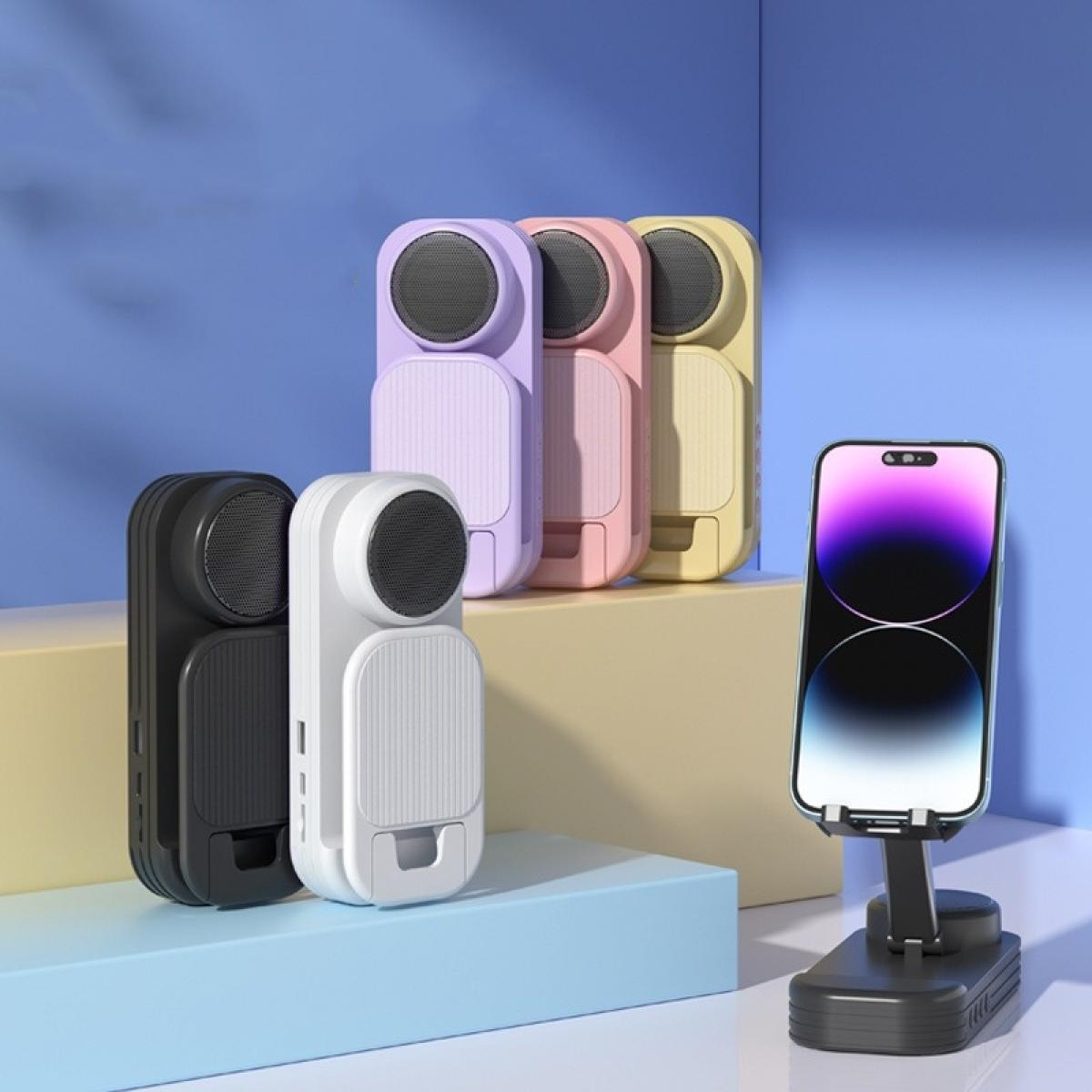Verschiedenfarbige tragbare Lautsprecher und ein Smartphone auf einem Ständer vor blauem Hintergrund.