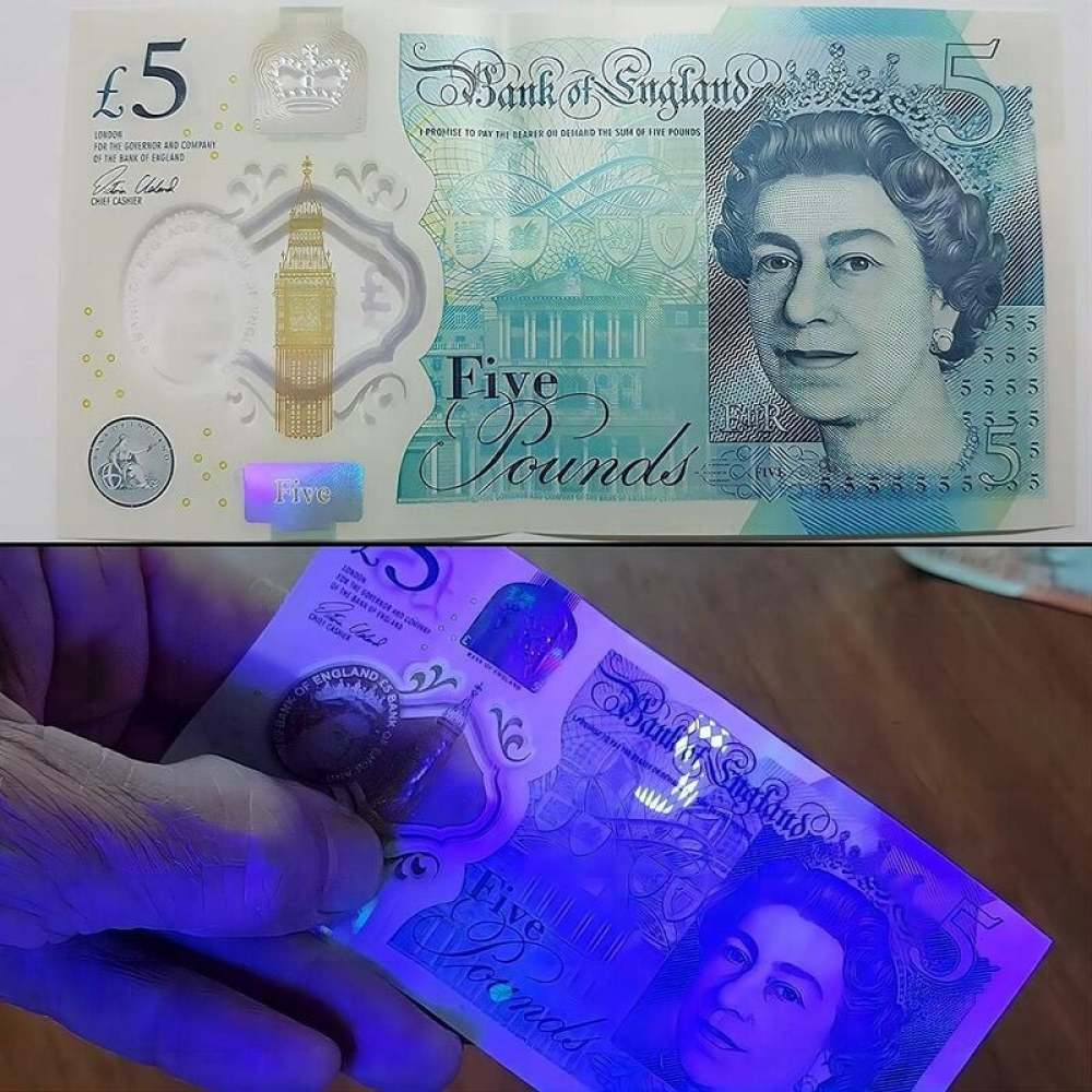 Ein Fünf-Pfund-Schein, der Königin Elisabeth II., Big Ben und ein Sicherheitsmerkmal unter UV-Licht zeigt.