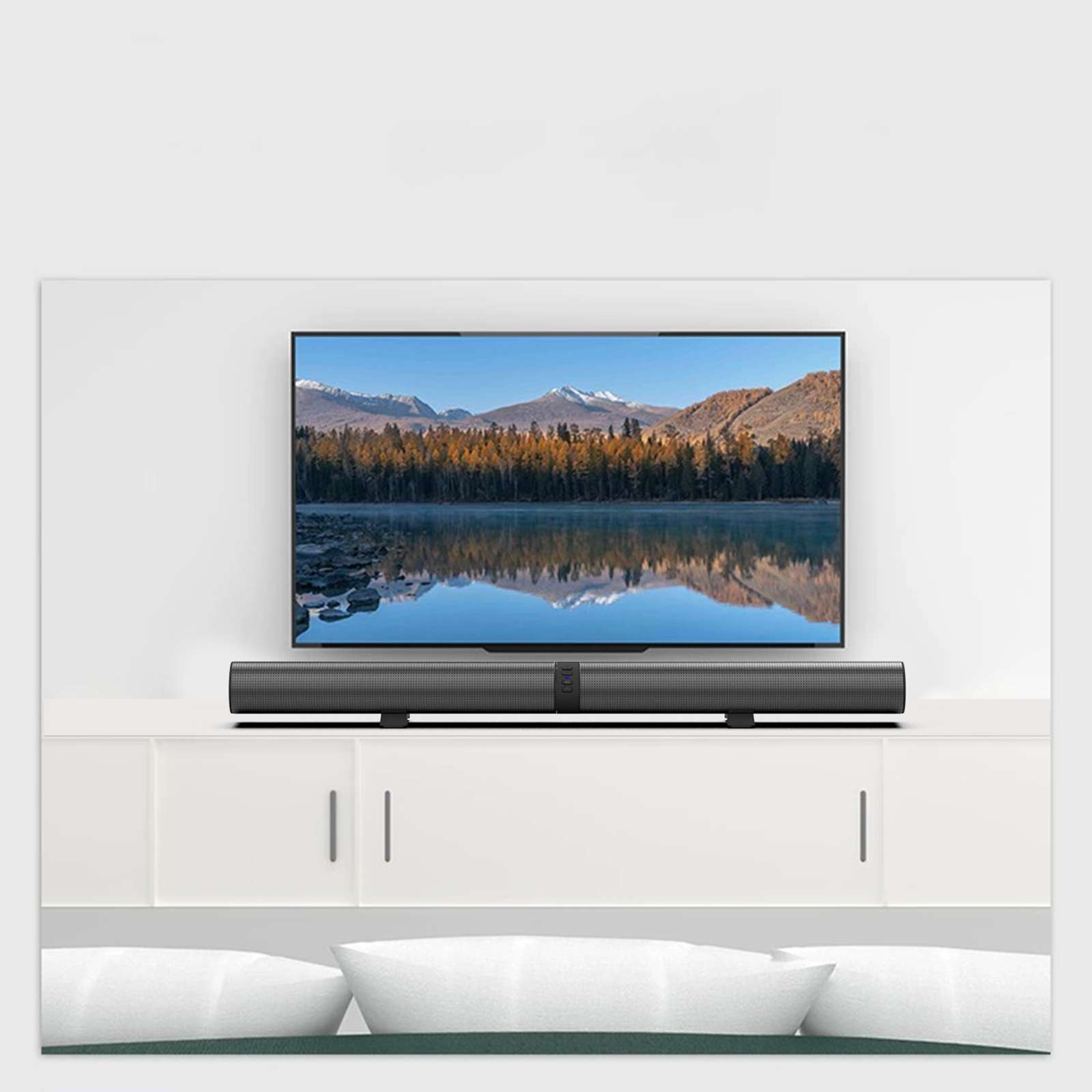 Ein Fernseher mit einer Landschaftsszene mit See und Bergen. Unter dem Fernseher befindet sich eine Soundbar, und der Fernseher befindet sich über einem weißen Schrank.