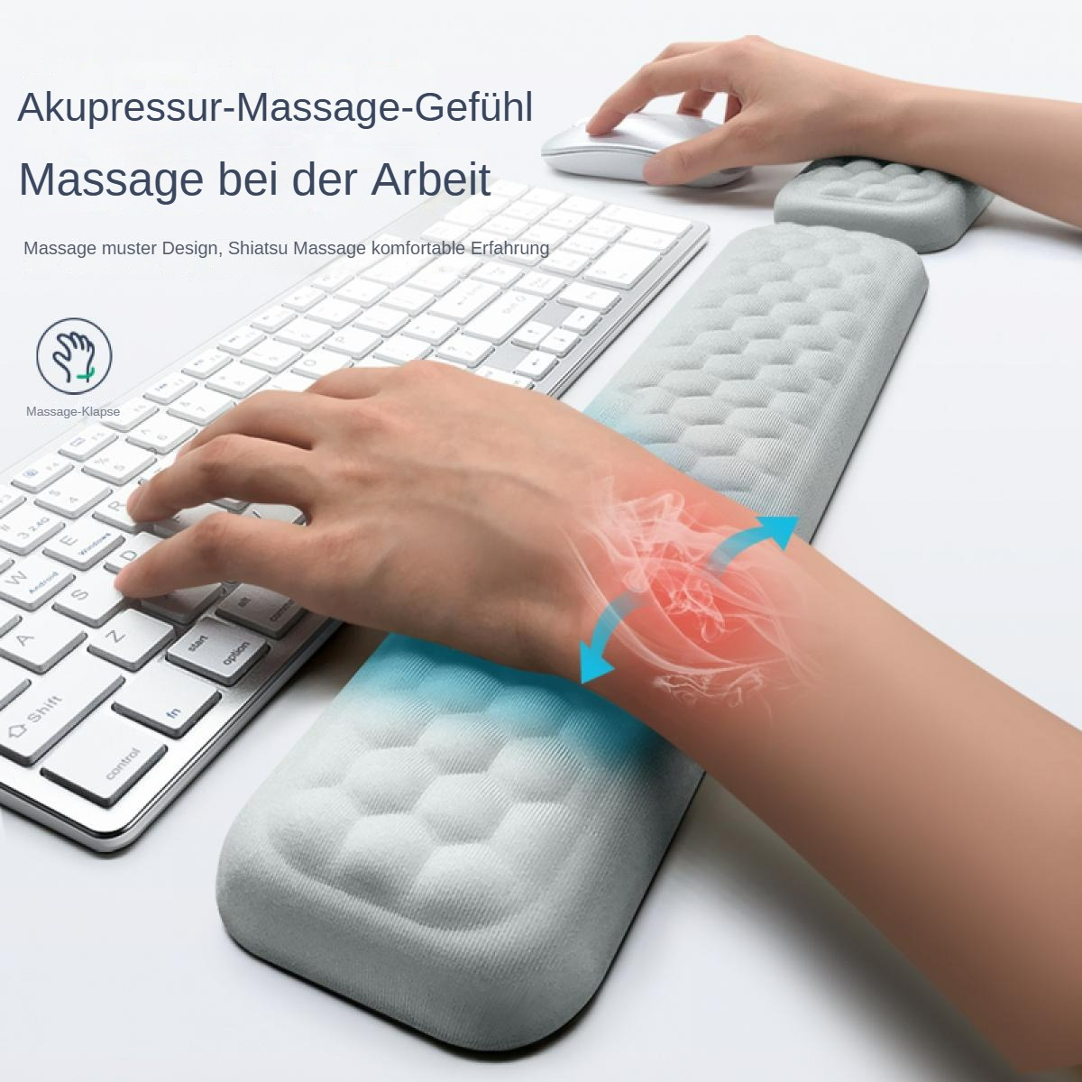 Eine Person benutzt eine Tastatur mit Handgelenkauflage. Das Bild zeigt eine Hand, die auf dem Pad ruht, mit rotem Schein.