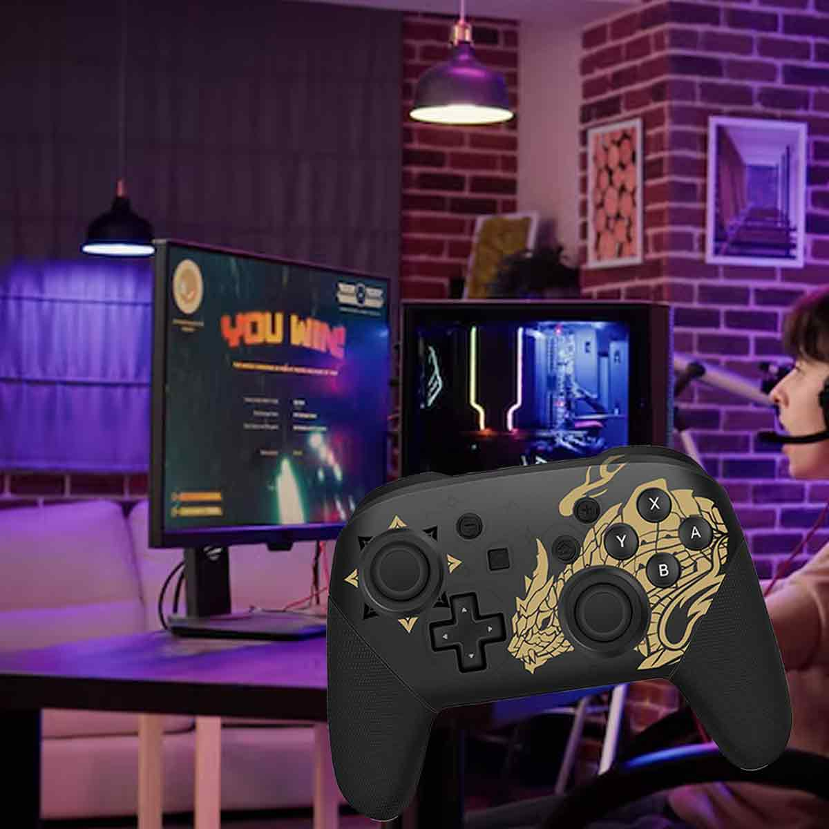 Ein schwarzer Gamecontroller mit goldenem Drachendesign. Ein Monitor zeigt 'You Win'. Eine Person trägt ein Headset. Ziegelmauer im Hintergrund.