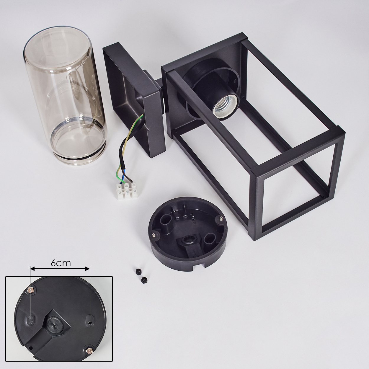 Zerlegte schwarze Außenlampe mit Glaszylinder, Sockel und elektrischen Komponenten auf weißem Hintergrund. 6cm Messung.