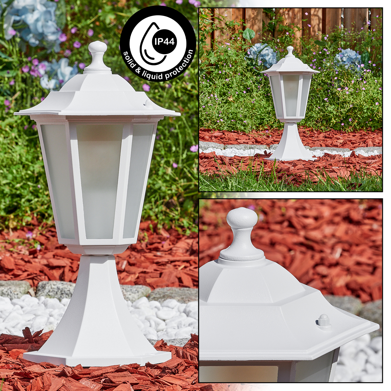 Eine weiße Außenlampe mit Milchglas, in einem Garten mit roter Mulche, weißen Steinen und Grün im Hintergrund.