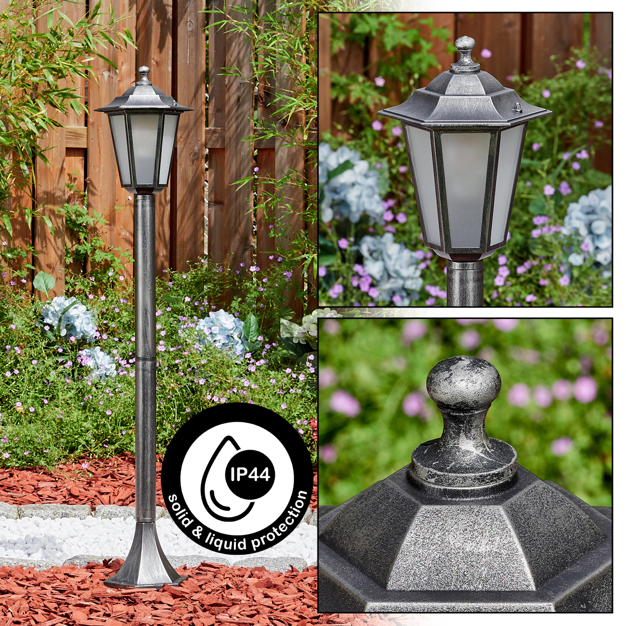 Eine silberne Laterne in einem Garten. Die Lampe ist von Blumen und einem Holzzaun umgeben. Sie hat IP44-Schutz.