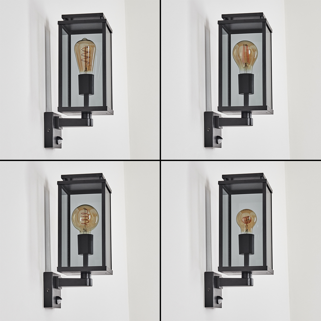 Vier schwarze Außenlampen sind an einer weißen Wand montiert. Jede Lampe hat ein Glasgehäuse und eine warme Glühbirne.