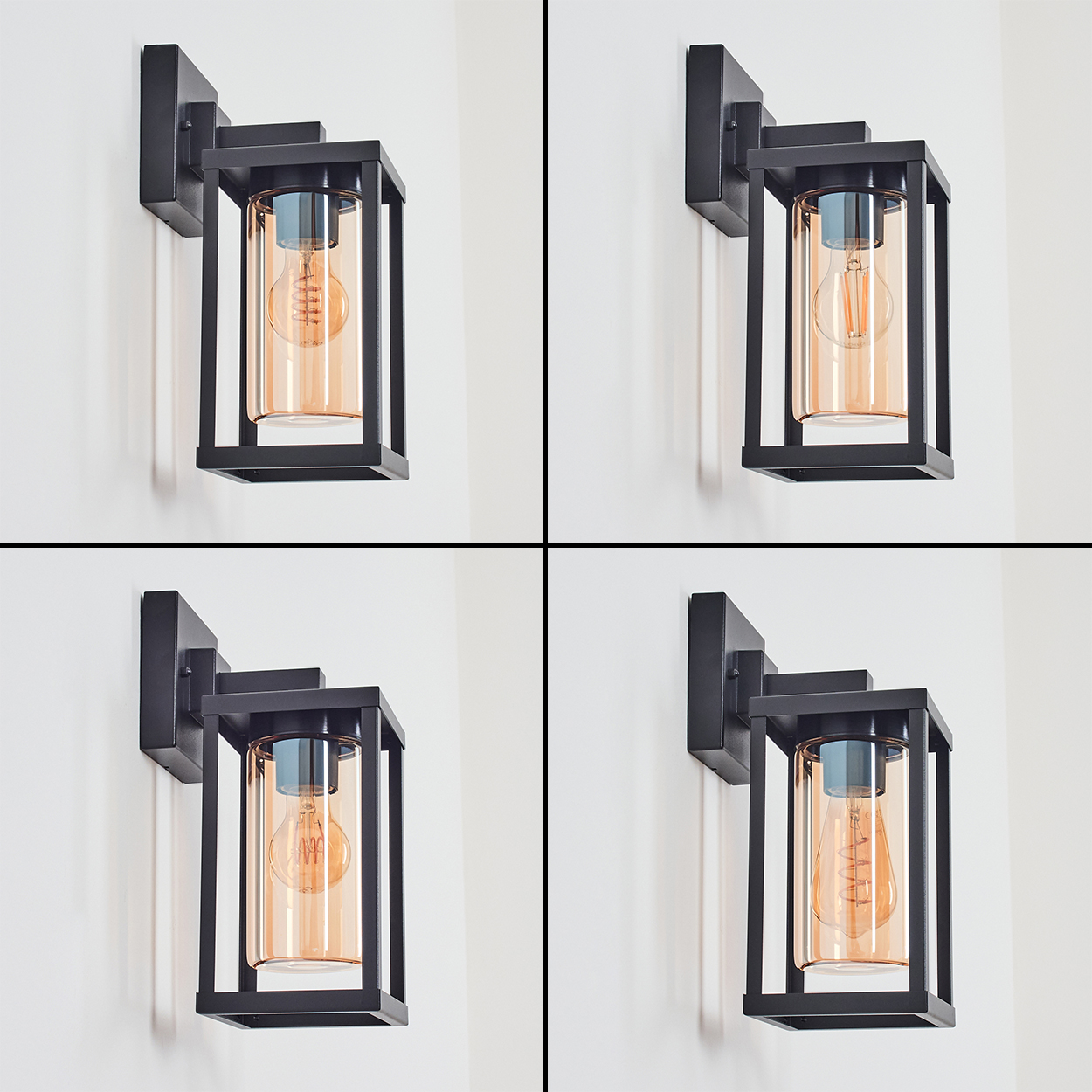 Vier Wandlampen mit schwarzen Rahmen und bernsteinfarbenen Glasschirmen sind an einer weißen Wand montiert.