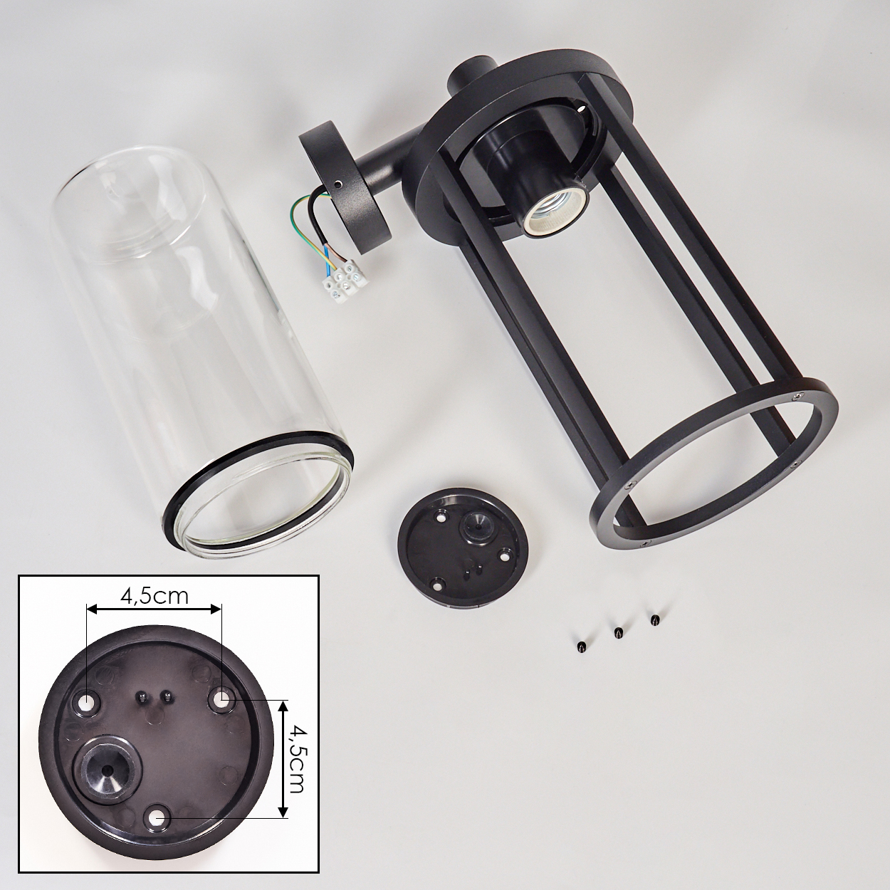 Zerlegte schwarze Lampenkomponenten: zylindrisches Glas, Metallrahmen, Sockel und Schrauben. Ein detailliertes Basisdiagramm mit Maßen ist ebenfalls vorhanden.