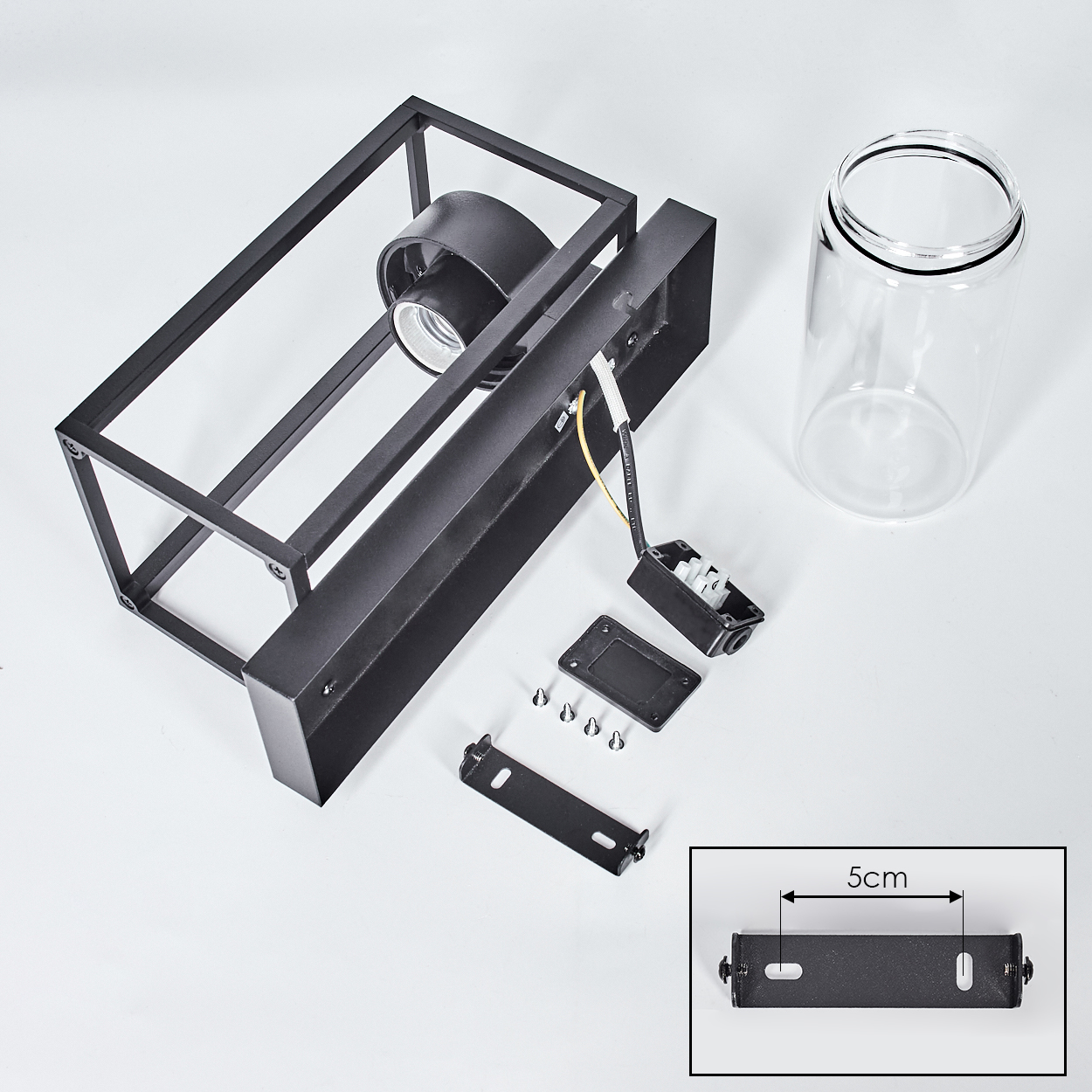 Schwarze, rechteckige Leuchtenkomponenten. Enthält einen Glaszylinder, Montagehalterungen, Schrauben und Kabel auf weißem Hintergrund.