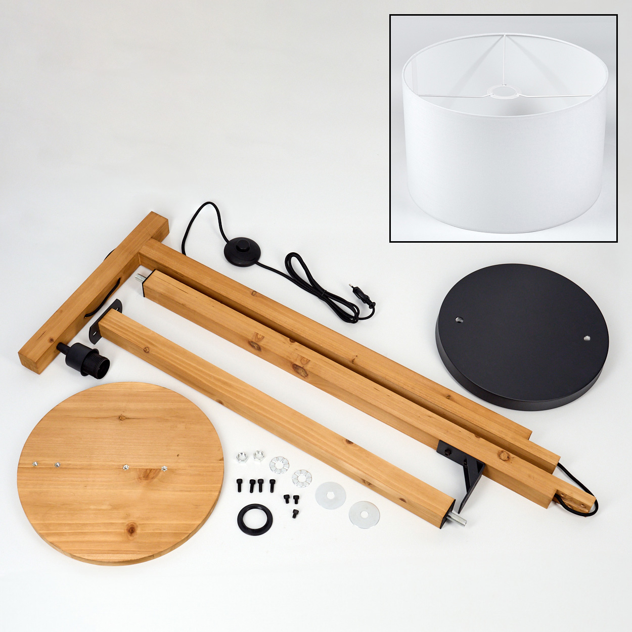 Zerlegte Holz-Stehlampe mit Schirm. Teile umfassen Holzbalken, runde Sockel, Metallbeschläge, Netzkabel und einen weißen Lampenschirm.