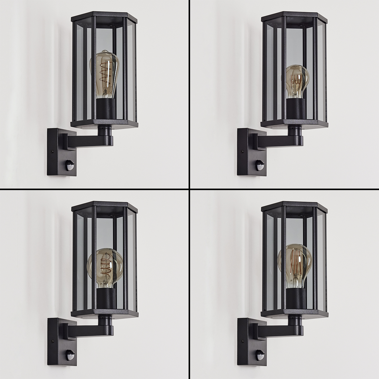 Vier schwarze Außenlampen mit Glasscheiben und Edison-Glühbirnen sind an einer weißen Wand befestigt. Jede hat einen Sensor.