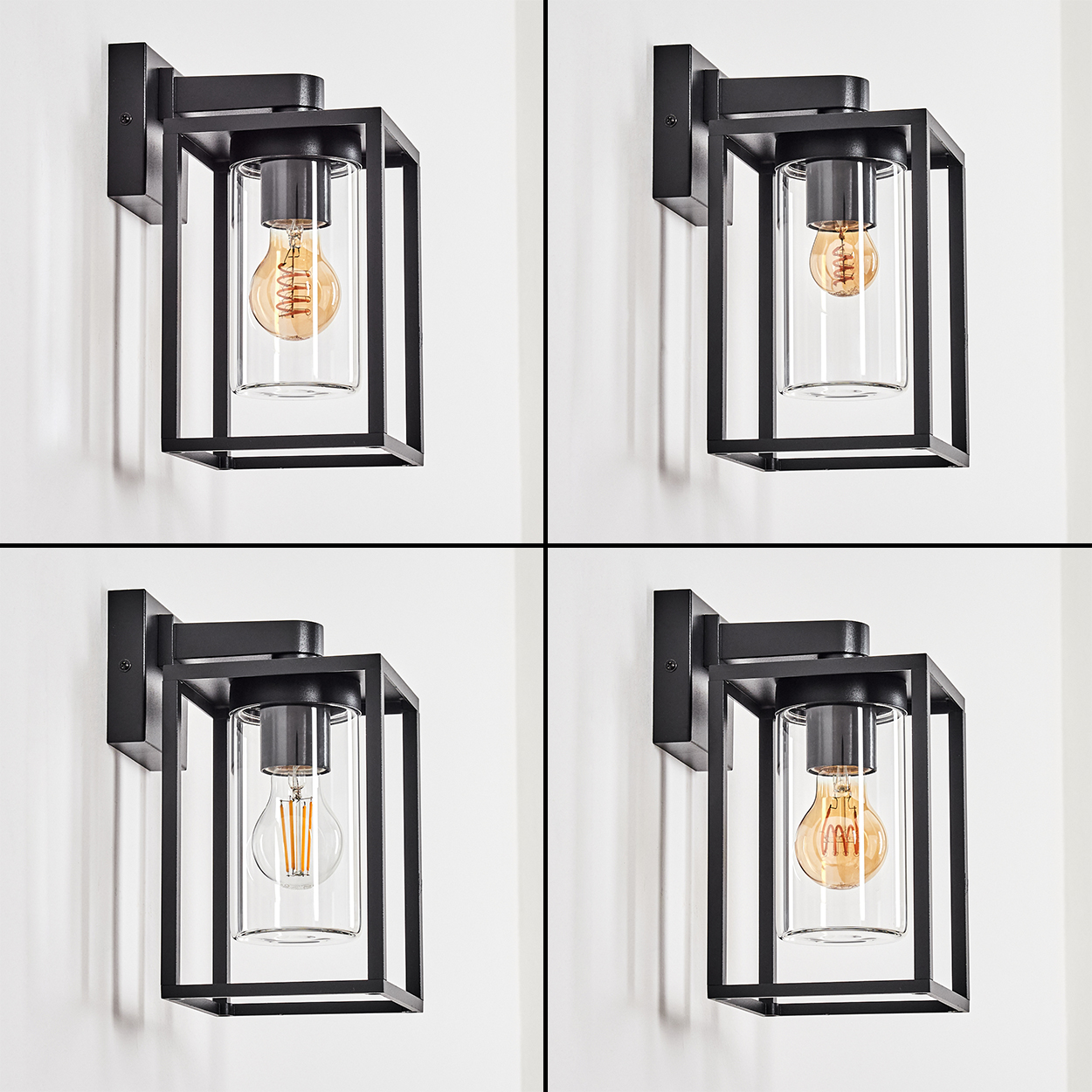 Vier schwarze Wandleuchten mit Glasgehäusen und Glühbirnen im Edison-Stil an einer weißen Wand.