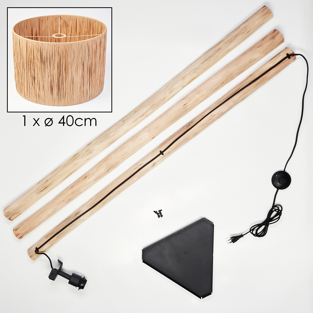 Lampenteile. Ein Lampenschirm, Holzstangen, ein schwarzer Sockel, Schrauben und ein Netzkabel liegen auf weißem Untergrund.