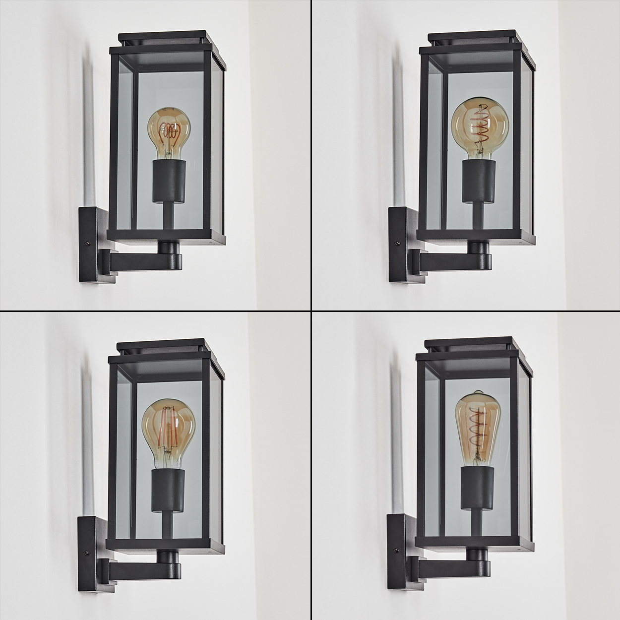 Vier schwarze Außenlampen mit klaren Glasscheiben und sichtbaren Glühbirnen sind an einer weißen Wand montiert.