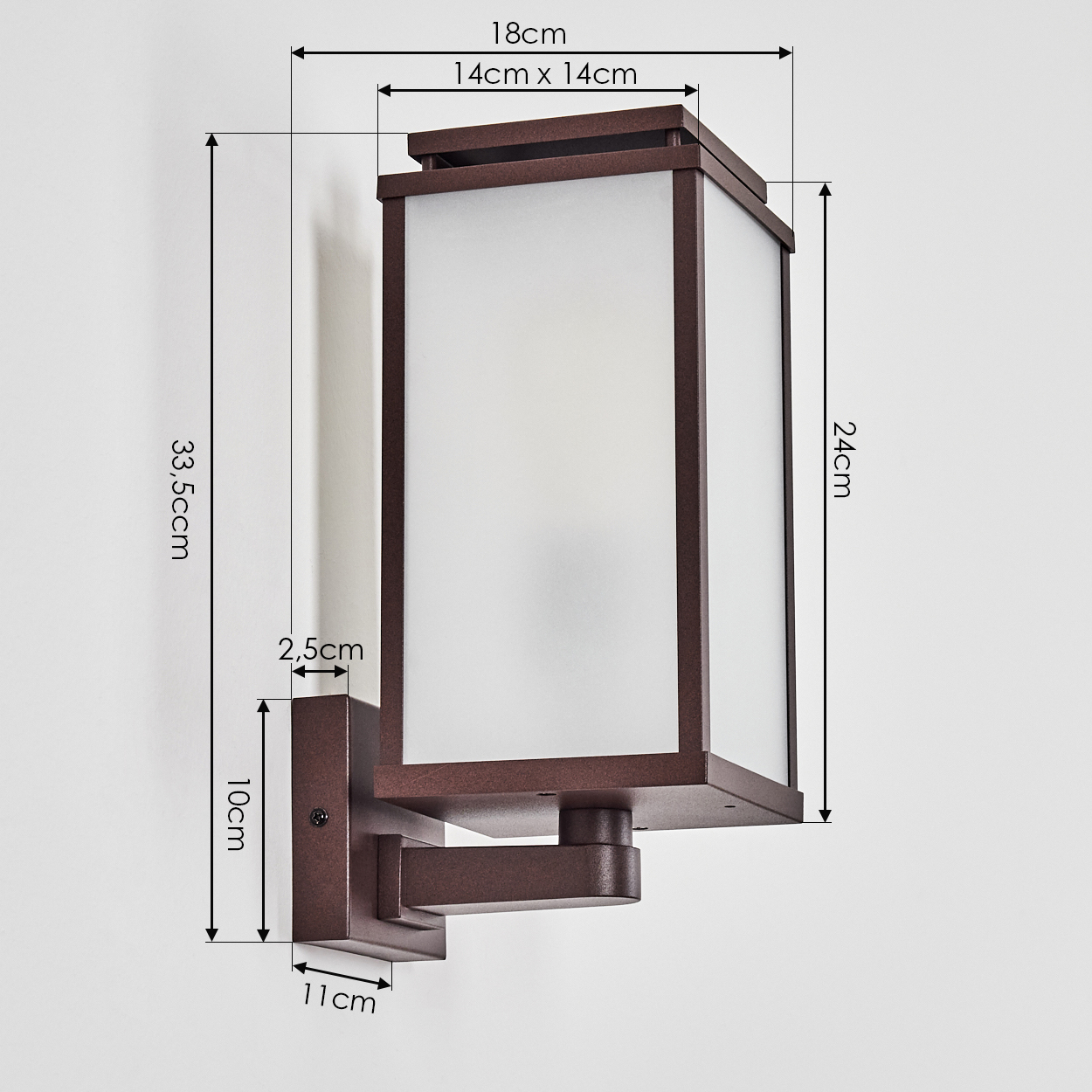 Eine braune, rechteckige Außenwandleuchte mit angegebenen Abmessungen. Sie hat eine Milchglasscheibe und ist an einer weißen Wand montiert.