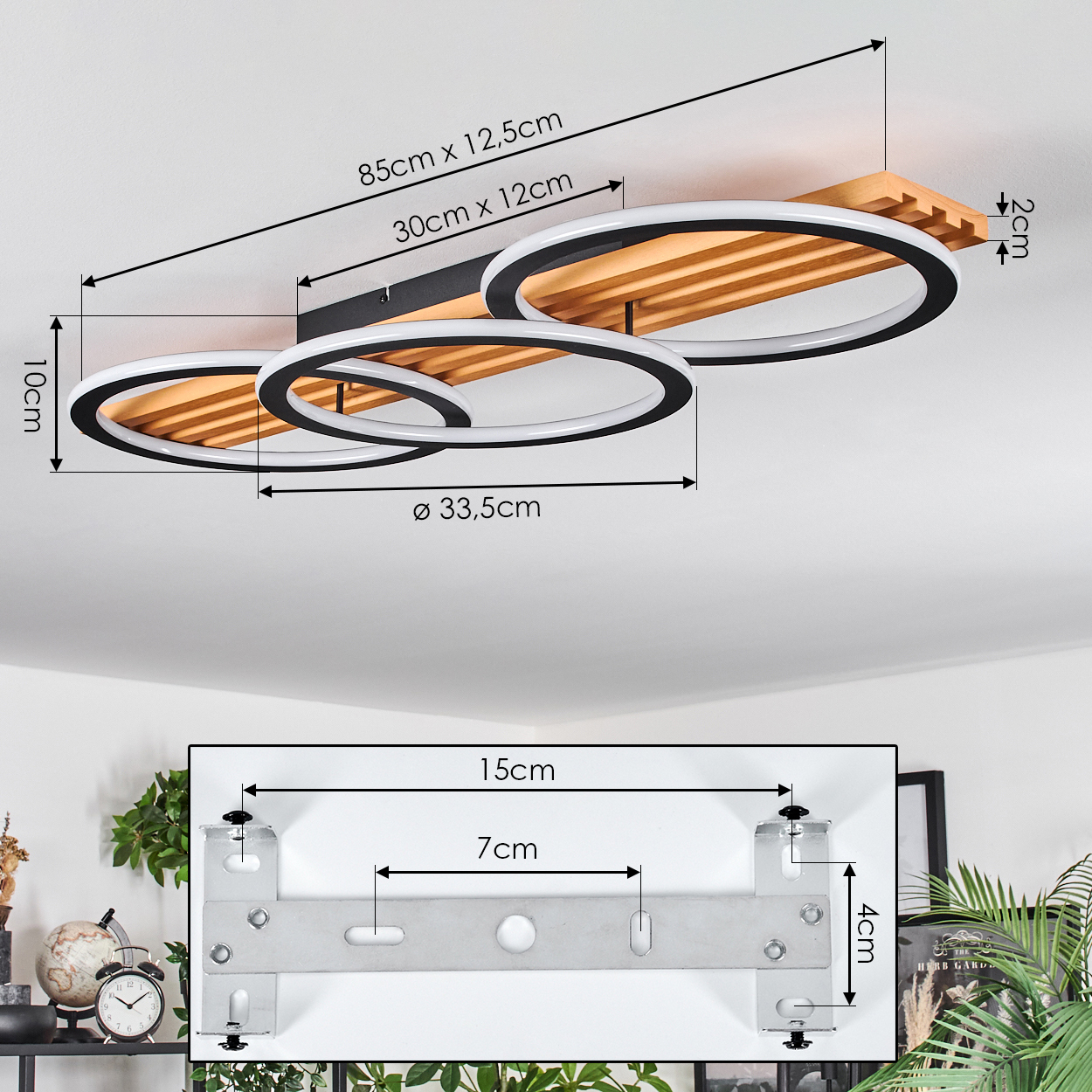 Eine Deckenlampe mit drei kreisförmigen Lichtern, schwarz und weiß, auf Holzbasis. Abmessungen sind angegeben. Eine Metallhalterung ist unten gezeigt.