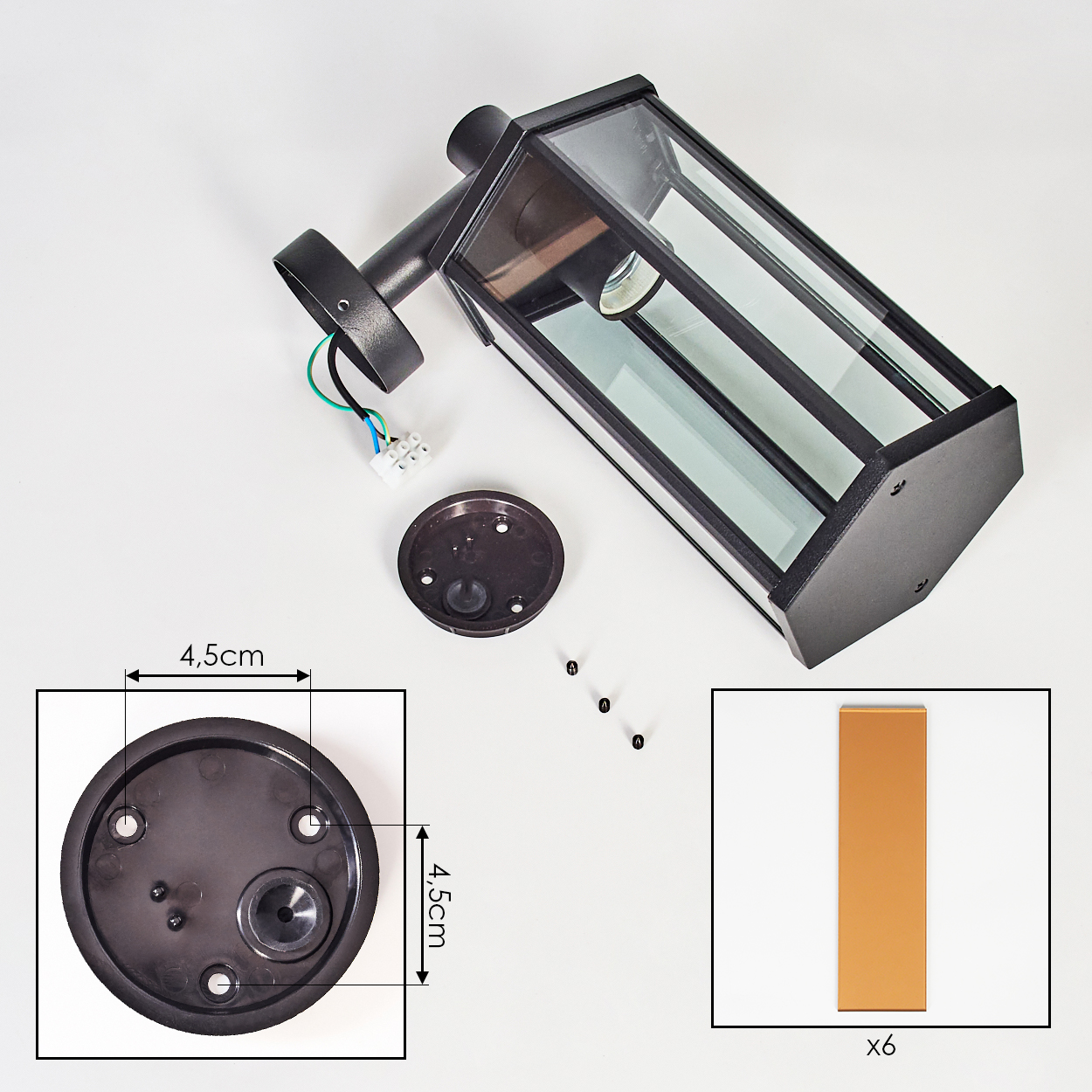 Schwarze Außenlampe mit Glasscheiben, zerlegt. Enthält Grundplatte, Schrauben und ein rechteckiges braunes Stück mit der Aufschrift 'x6'.