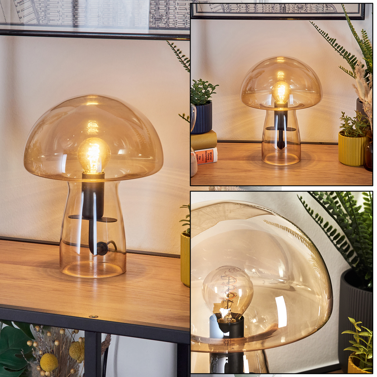 Eine pilzförmige Lampe aus bernsteinfarbenem Glas mit einer leuchtenden Glühbirne auf einer Holzoberfläche, umgeben von Pflanzen.