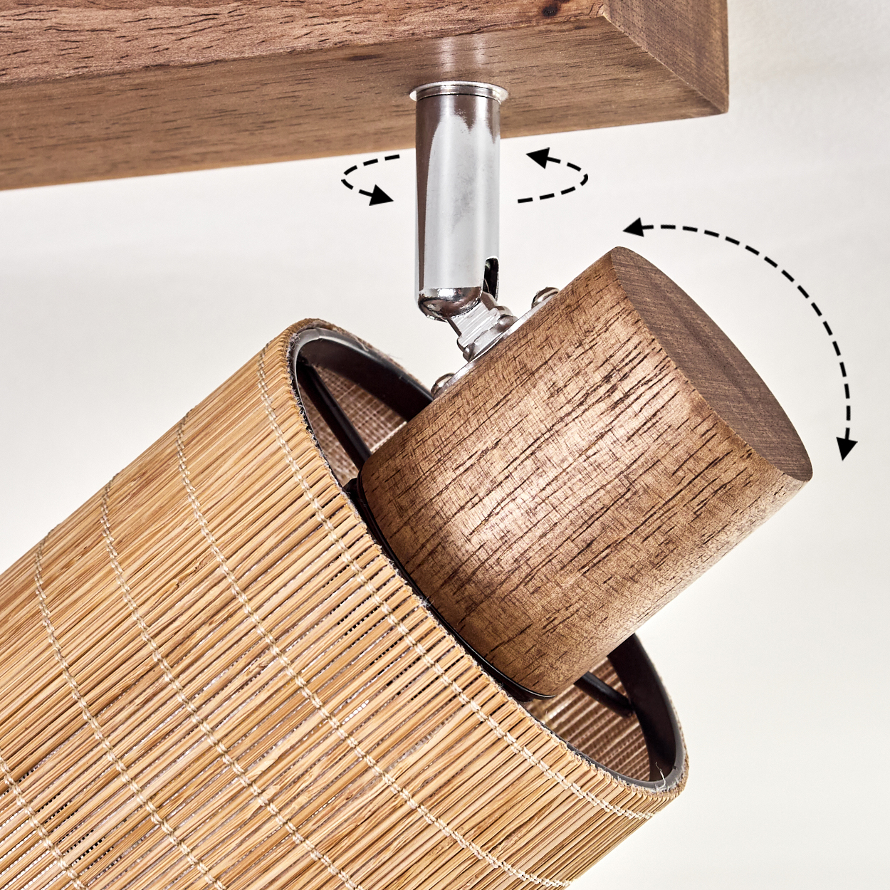 Ein Bambus-Lampenschirm mit Holzblock und Metallhalterung. Lampenschirm und Block sind verbunden, Pfeile zeigen Drehbewegung an.