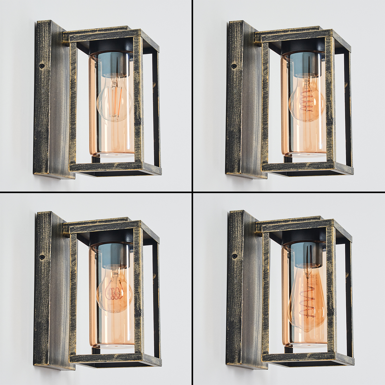 Vier Wandleuchten mit Edison-Glühbirnen in rechteckigen Rahmen. Metallarmaturen mit Gold- und Schwarz-Finish, an einer weißen Wand.