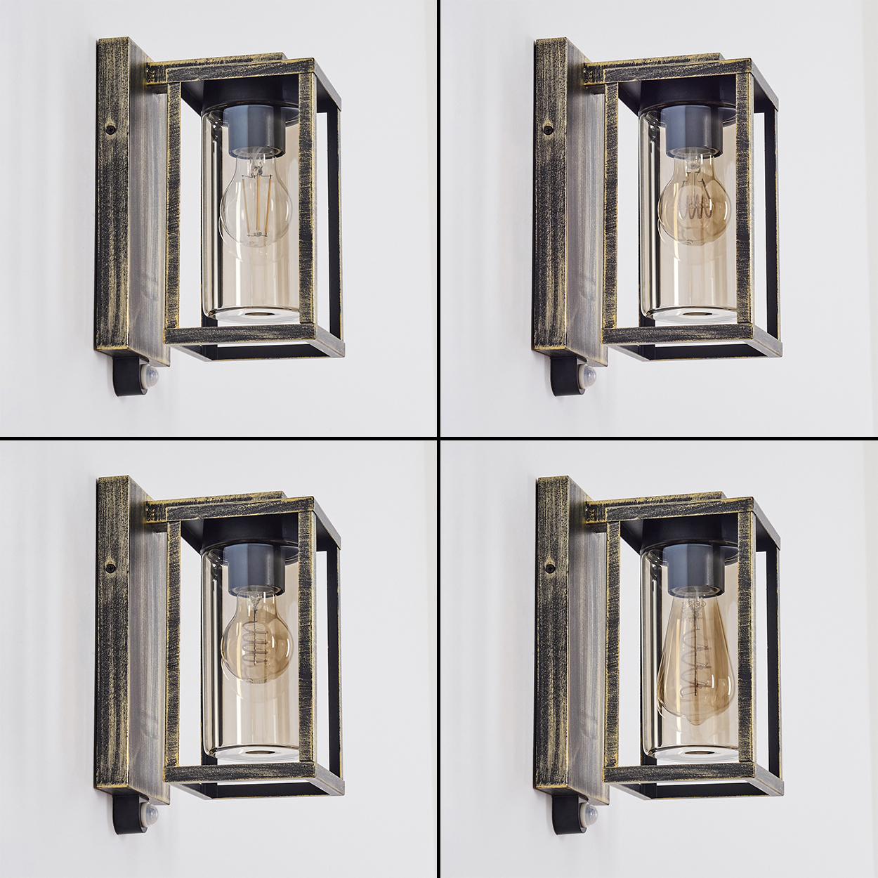 Vier Wandleuchten mit Edison-Glühbirnen. Jede hat einen schwarzen Rahmen und sitzt an einer weißen Wand. Die Glühbirnen leuchten warm.