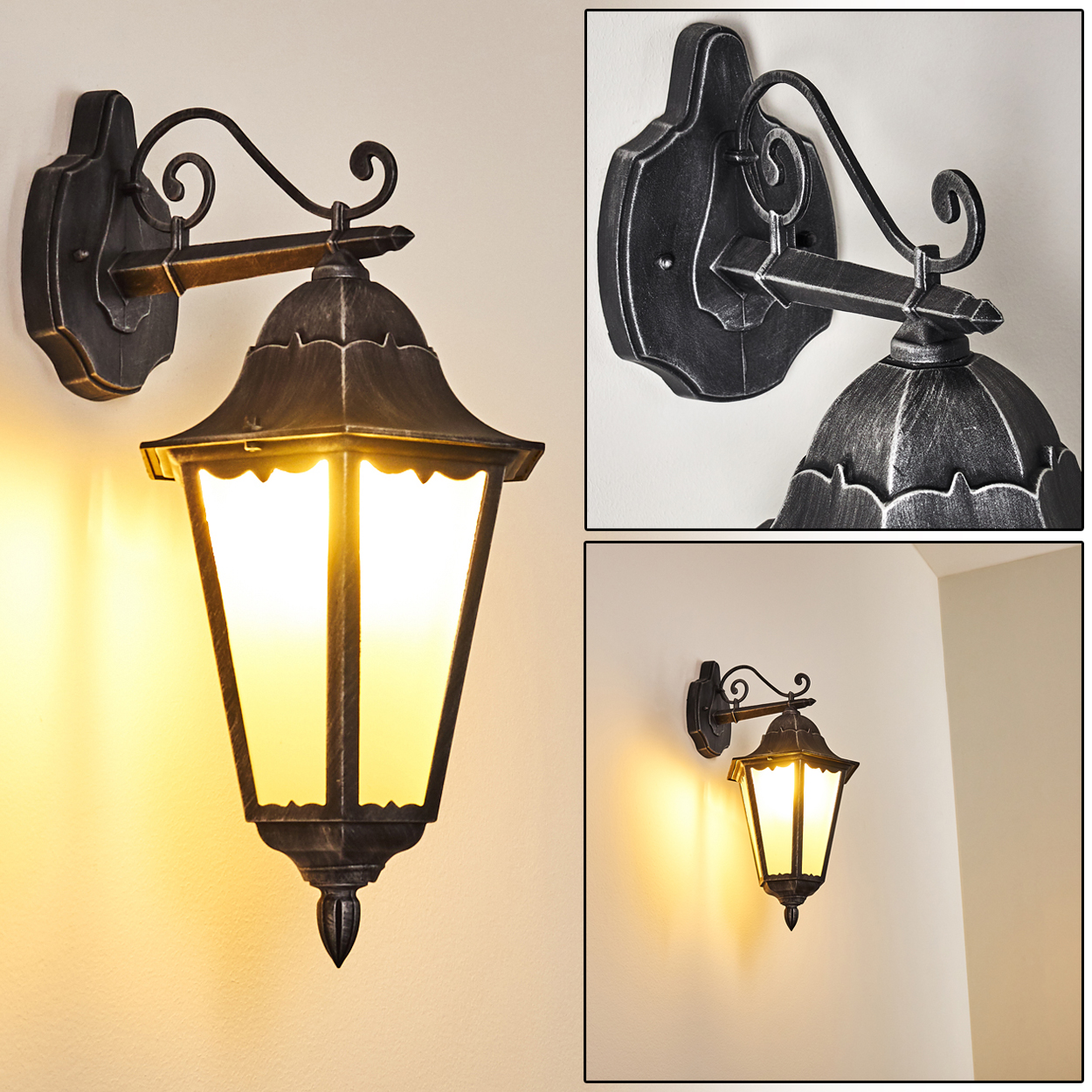 Eine verzierte, dunkle Metallwandleuchte mit warmgelbem Licht. Die Lampe ist an einer beigefarbenen Wand befestigt.