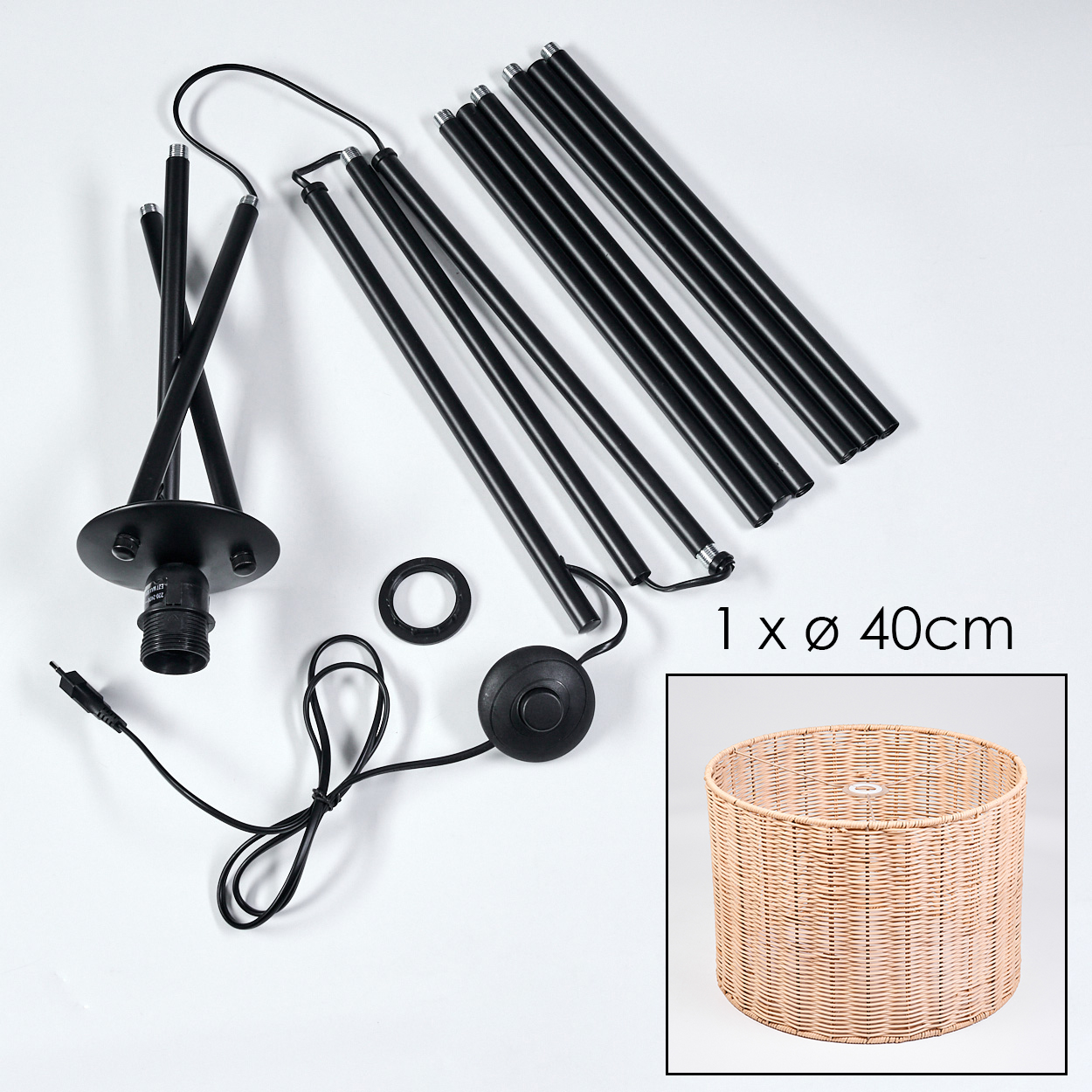 Komponenten einer Lampe liegen auf einer weißen Oberfläche verstreut. Enthält schwarze Stangen, einen Sockel, einen Lampenschirm und einen Fußschalter.
