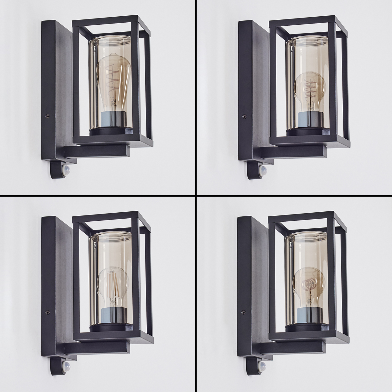 Vier schwarze Wandlampen mit Glasschirmen und sichtbaren Glühbirnen sind an einer weißen Wand befestigt. Jede Lampe hat einen Sensor.