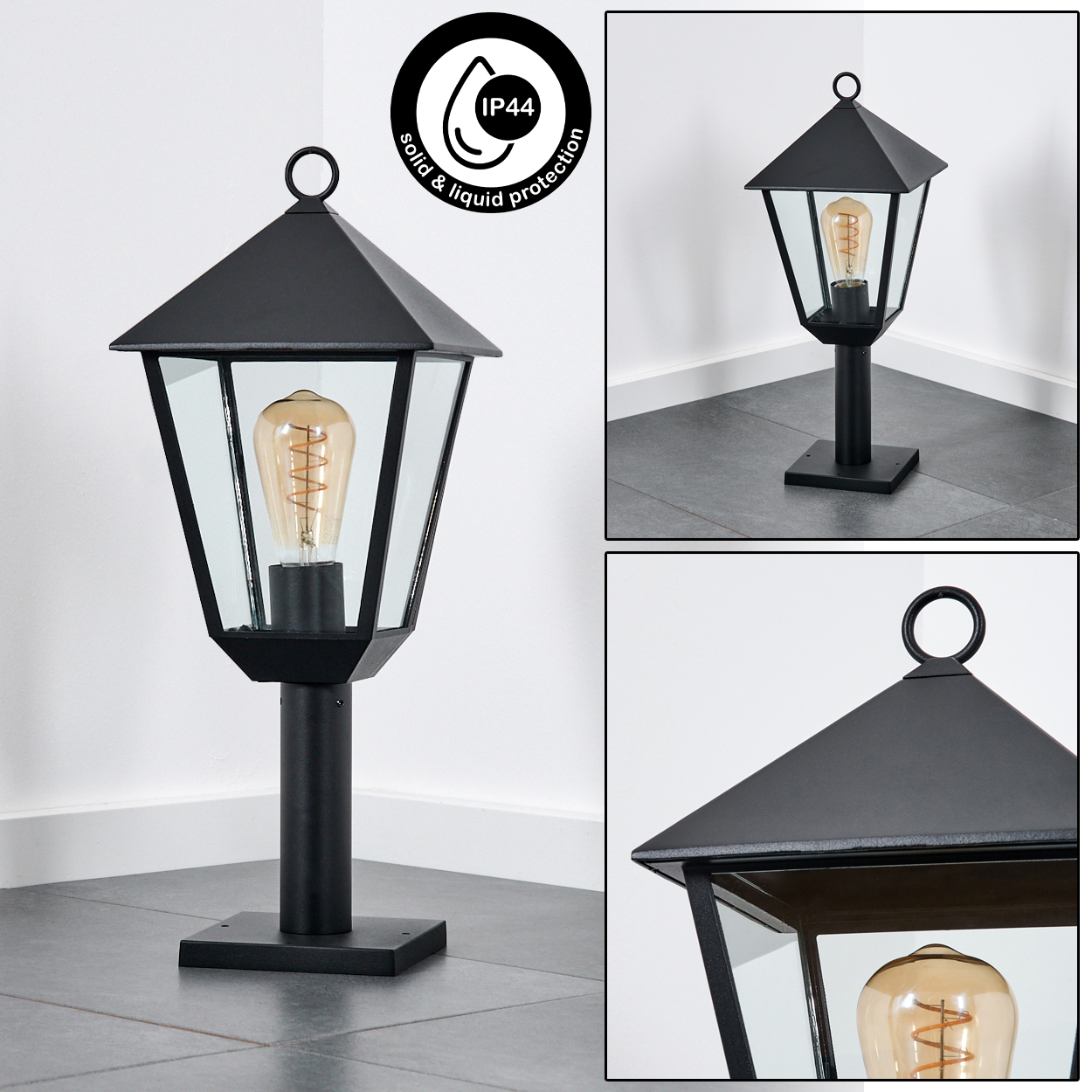 Schwarze Außenlampe mit Glasscheiben und einer sichtbaren Glühbirne. Sie hat einen Ring oben und steht auf einem Fliesenboden.