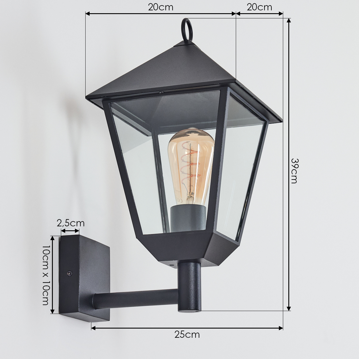Schwarze Wandlampe mit Maßen. Die Lampe hat ein Retro-Design mit Glasscheiben und einer sichtbaren Glühbirne. Sie ist an einer weißen Wand befestigt.